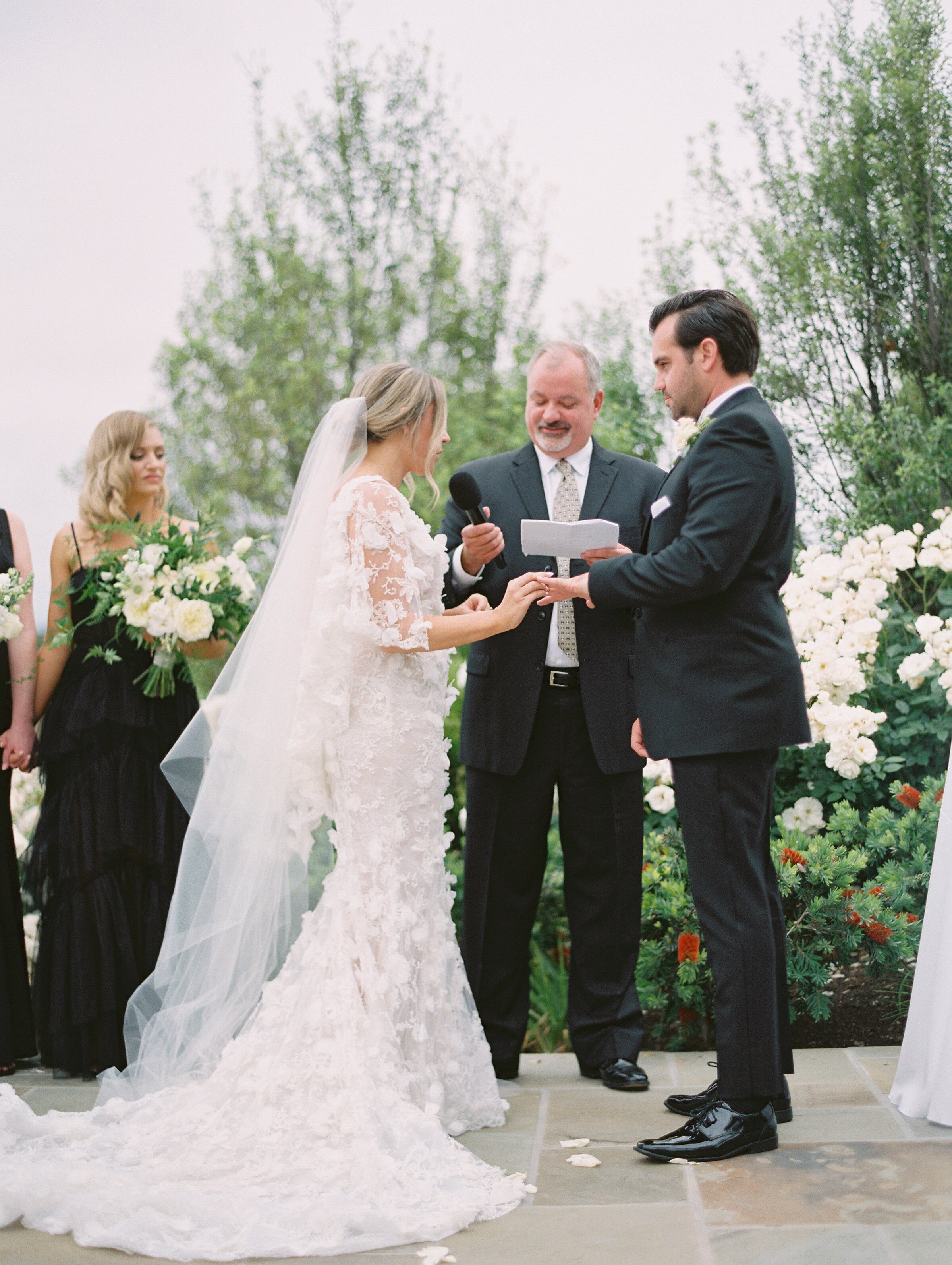 www.santabarbarawedding.com | Roblar Farm | Smith and Murphy | Esther Sun | Velvet Blooms | Ventura Rentals | Marchesa | Janet Villa | Bride Places Ring on Groom’s Finger During Ceremony 