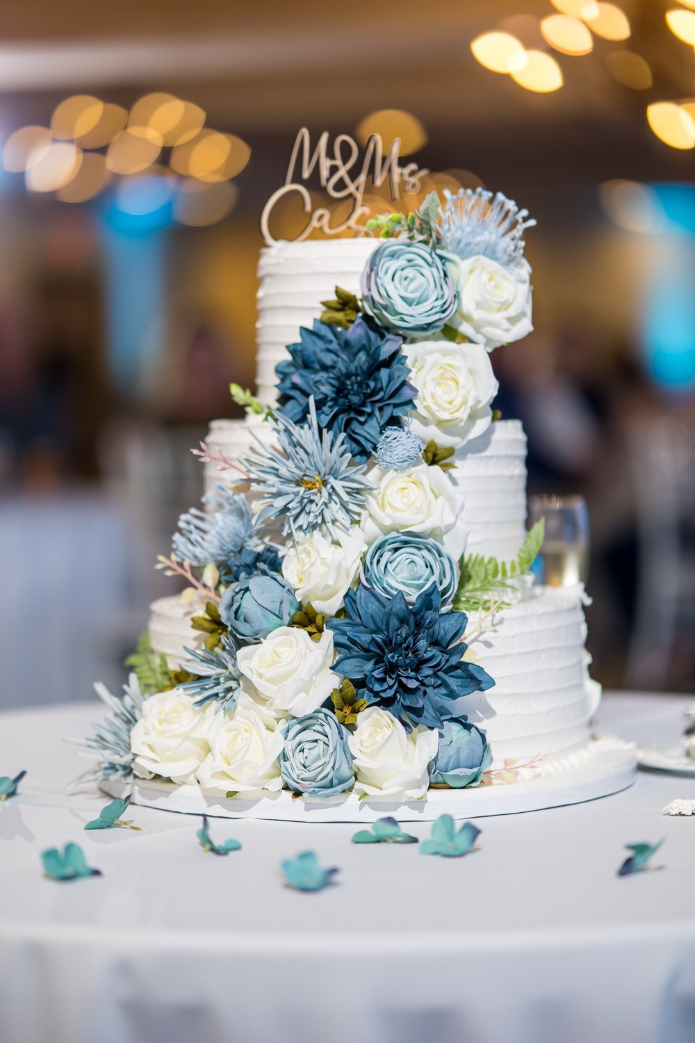 www.santabarbarawedding.com | Elizabeth Victoria | Hilton Mandalay Beach Hotel | Three Sisters Event Planning | Blooming Ruby’s | Heavenly Cakes 805 | Three Tiered Wedding Cake with Blue Flowers