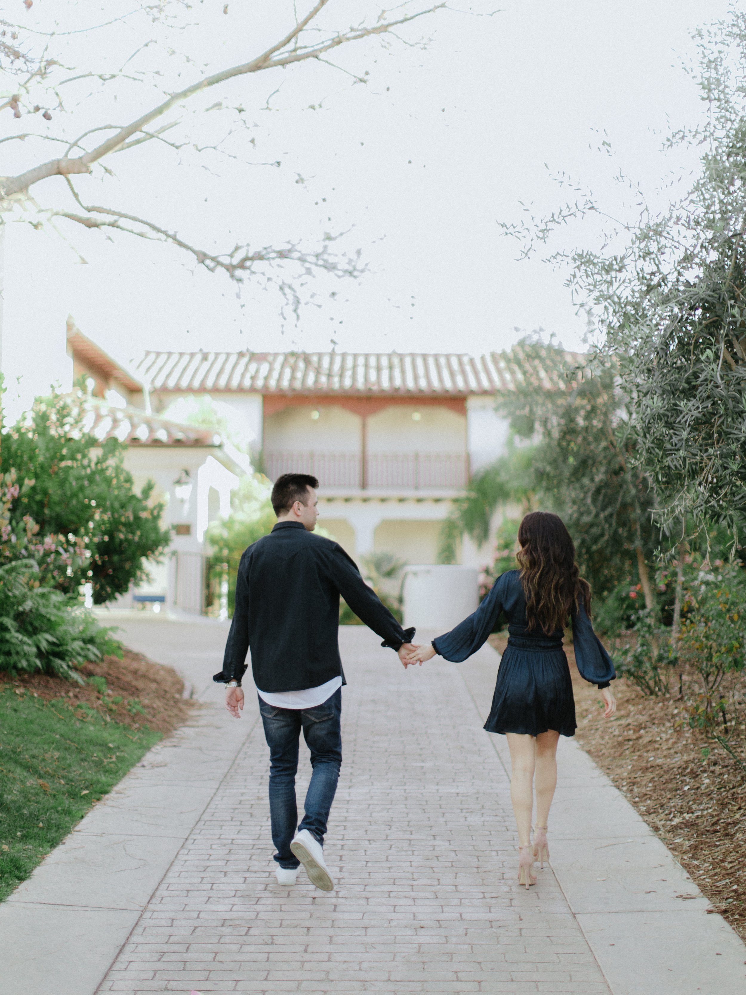 www.santabararawedding.com | Chris J. Evans | Santa Barbara Ritz-Carlton Bacara | Couple Holding Hands on the Walkway Between the Trees