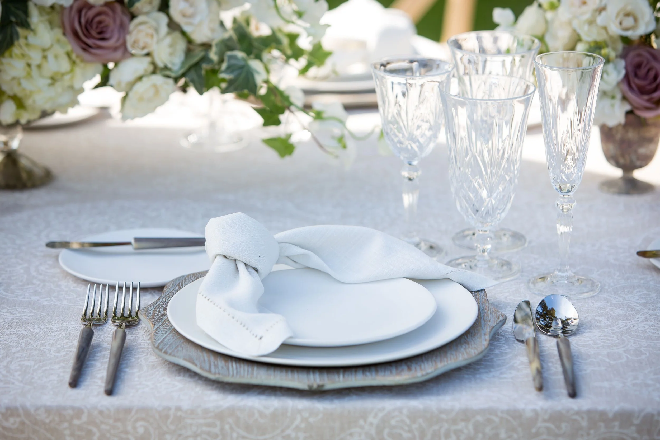 www.santabarbarawedding.com | Bright Event Rentals | Vanity Portrait Studio | Place Setting with White Plates on a Grey Charger and Crystal Glasses