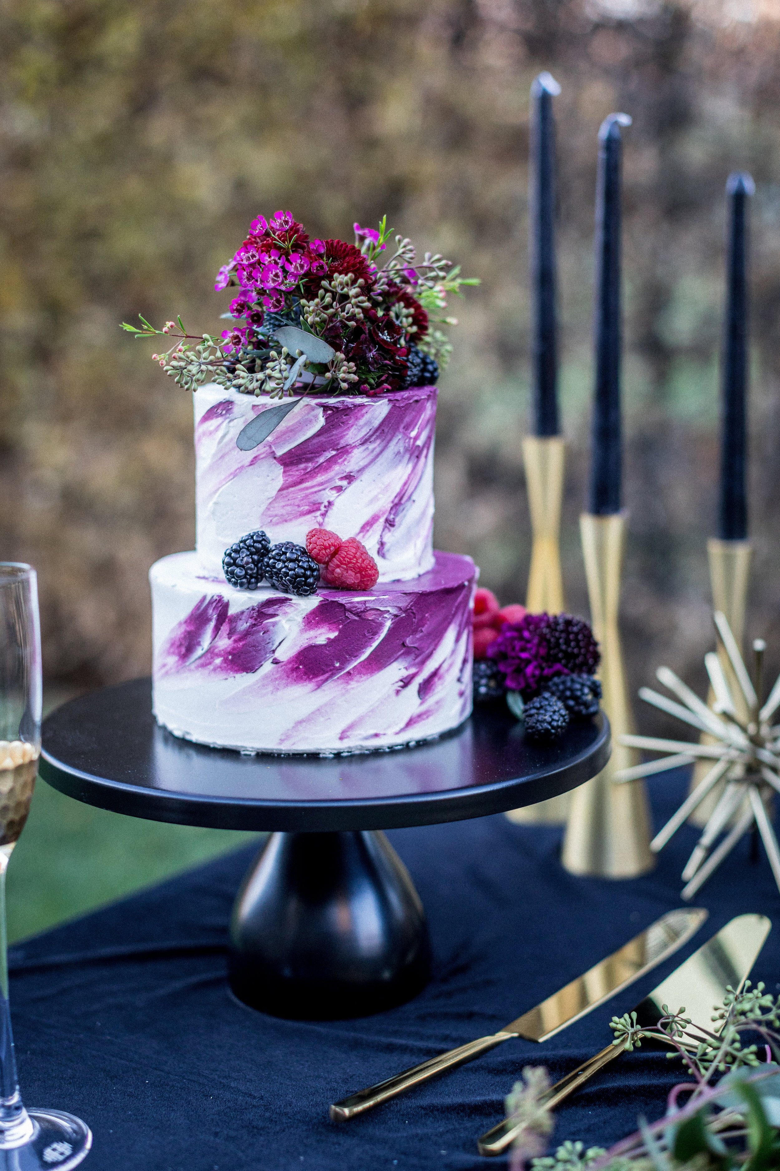 www.santabarbarawedding.com | Lilac Patisserie | Two-Tiered Purple and White Wedding Cake Topped with Berries and Purple and Pink Florals