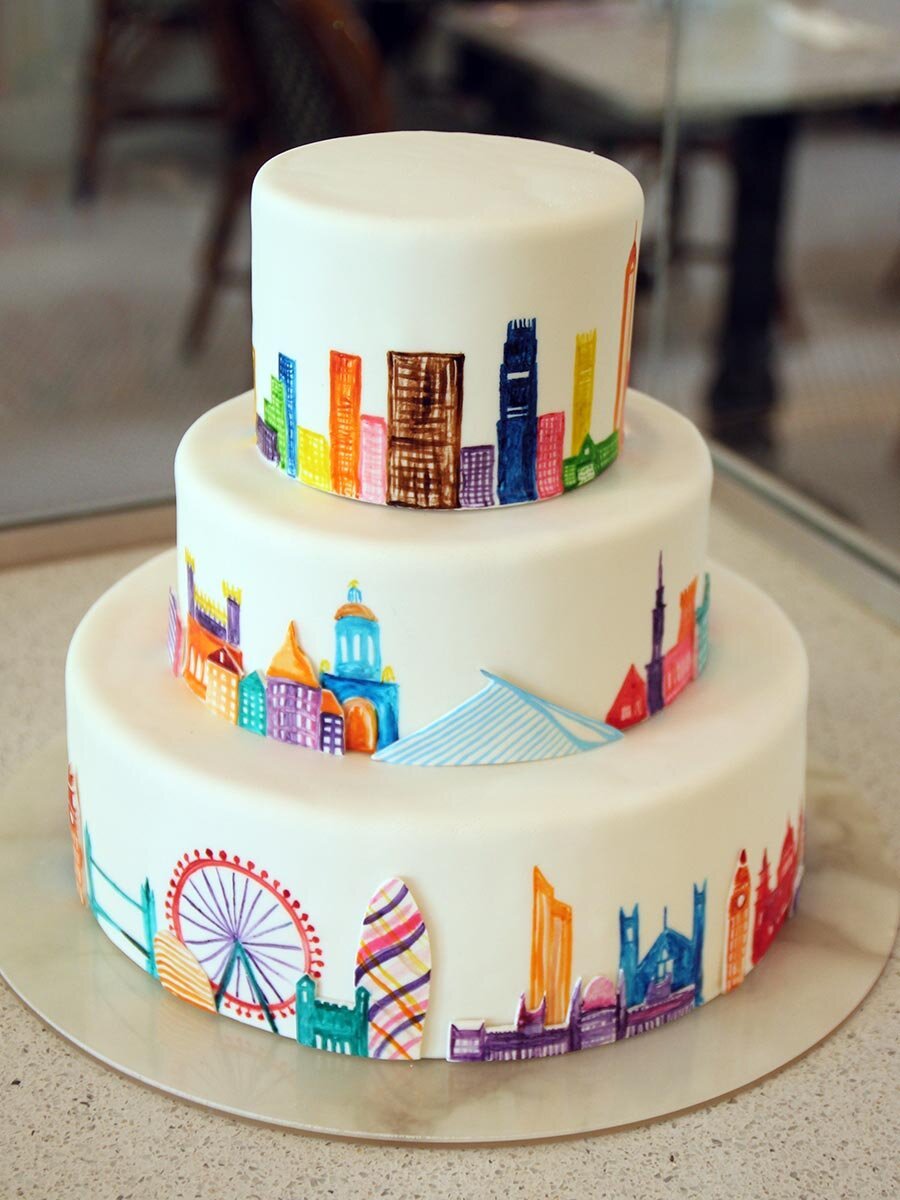 www.santabarbarawedding.com | Lilac Patisserie | Three-Tiered White Wedding Cake with Colorful Skyline Imagery 