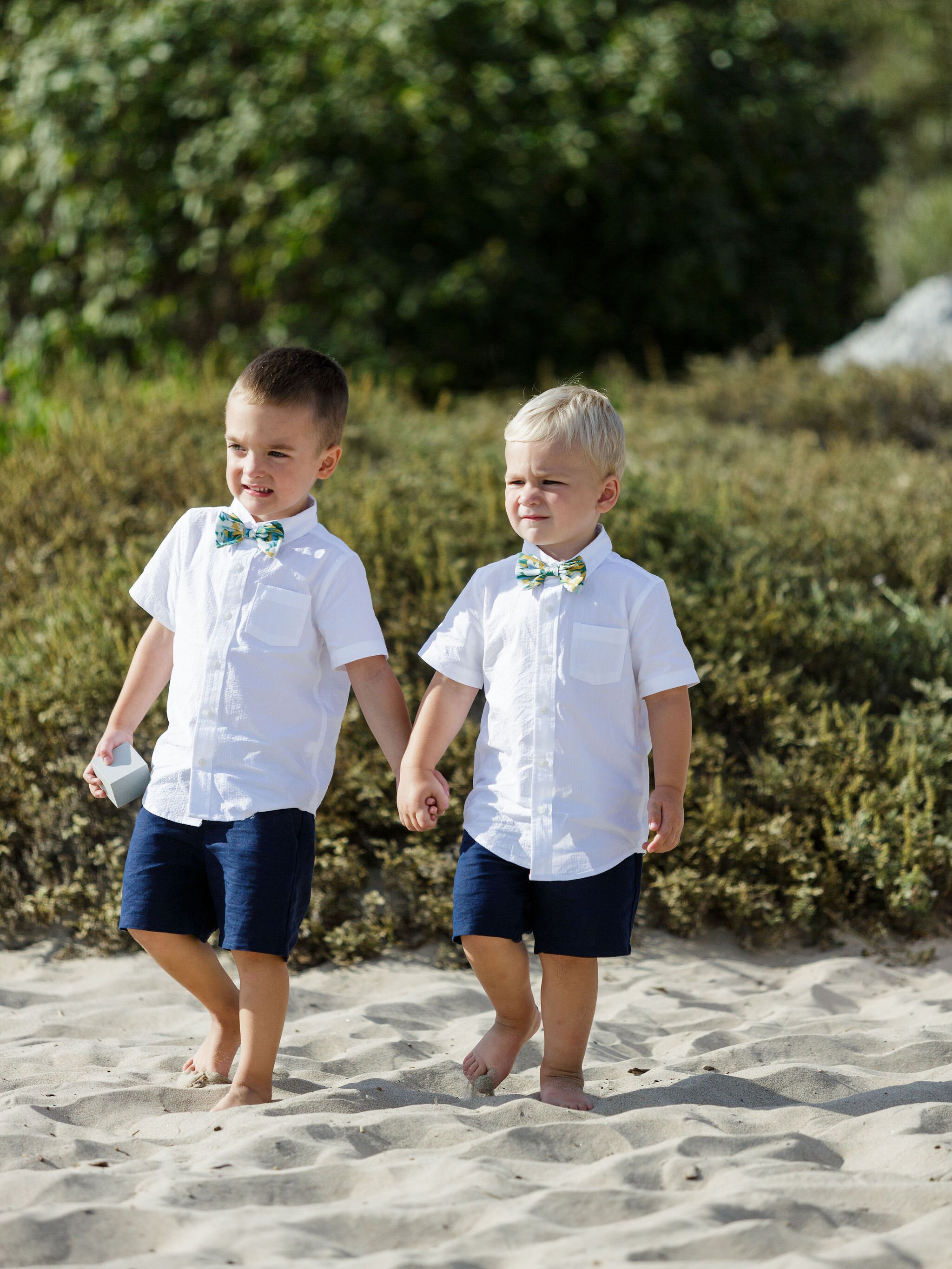 www.santabarbarawedding.com | Head &amp; Heart Photography | Rincon Beach Club | Events by Rincon | The Twisted Twig | Two Ring Bearers Walking Into the Ceremony 