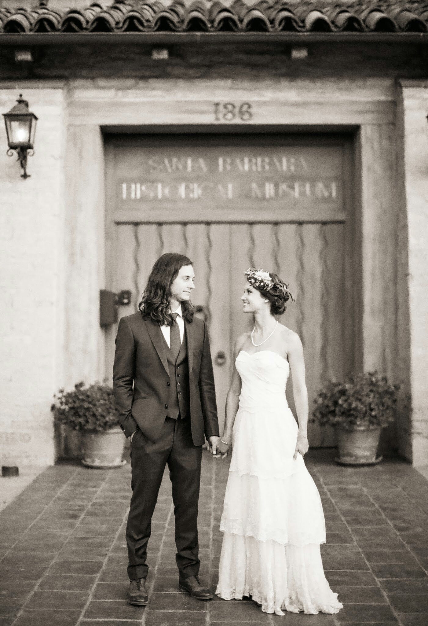 www.santabarbarawedding.com | Santa Barbara Historical Museum | Nancy Neil Photo | Couple in Front of the Front Door Sign
