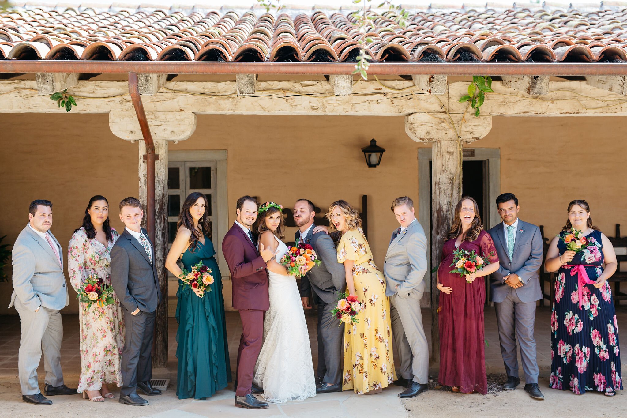 www.santabarbarawedding.com | Santa Barbara Historical Museum | Lerina Winter Photography | Couple and Wedding Party Under the Tiled Overhang Roof 