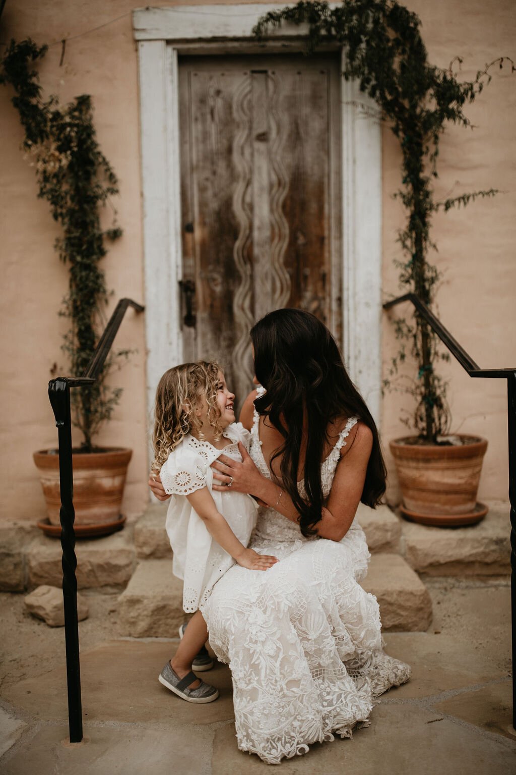 www.santabarbarawedding.com | Santa Barbara Historical Museum | Ashley Taylor Photography | Bride and Daughter in Front of Wooden Door