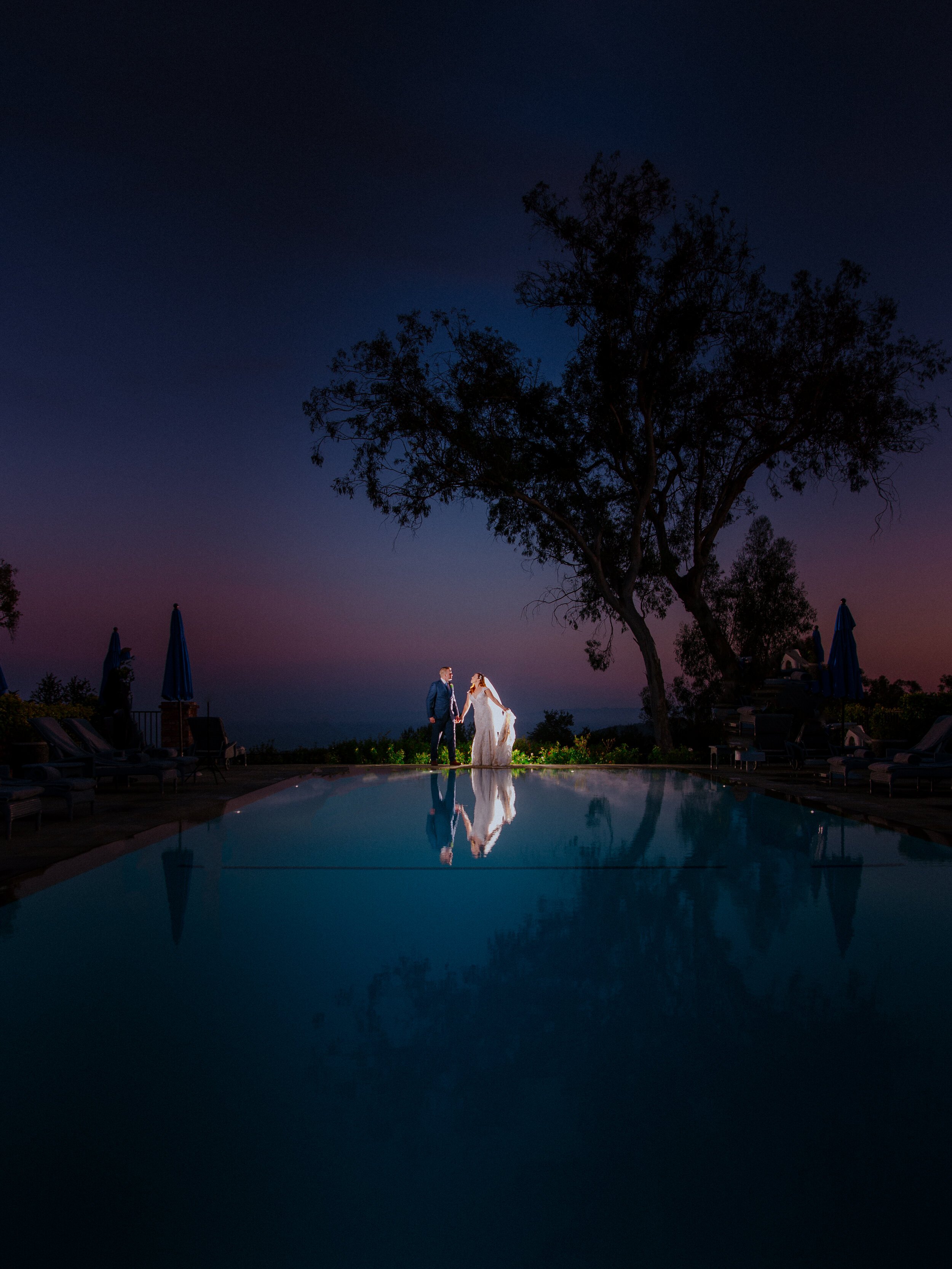 www.santabarbarawedding.com | Chris J Evans | Alegria by Design | Belmond El Encanto | Ella &amp; Louie | Brianna Olcese | Bride and Groom by the Pool Overlooking Santa Barbara at Night