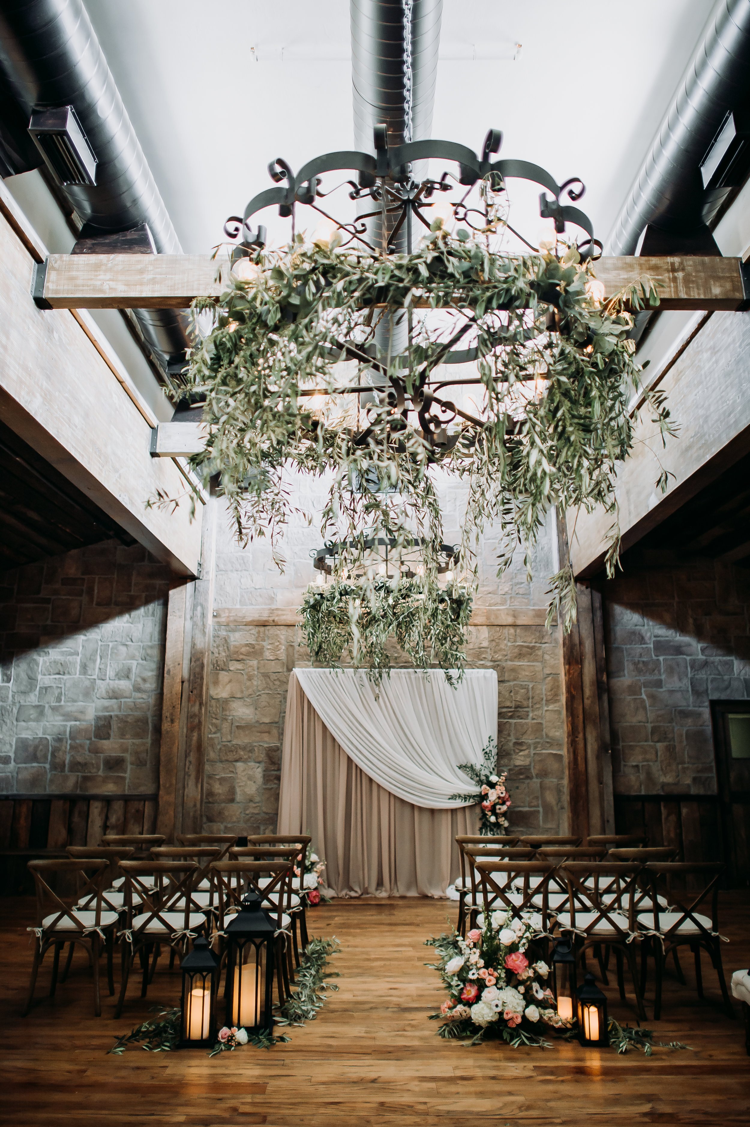 www.santabarbarawedding.com | Michelle Ramirez Photography | Tangled Lotus | Ceremony Aisle with Floral Arrangement Hanging from Overhead Light Fixture