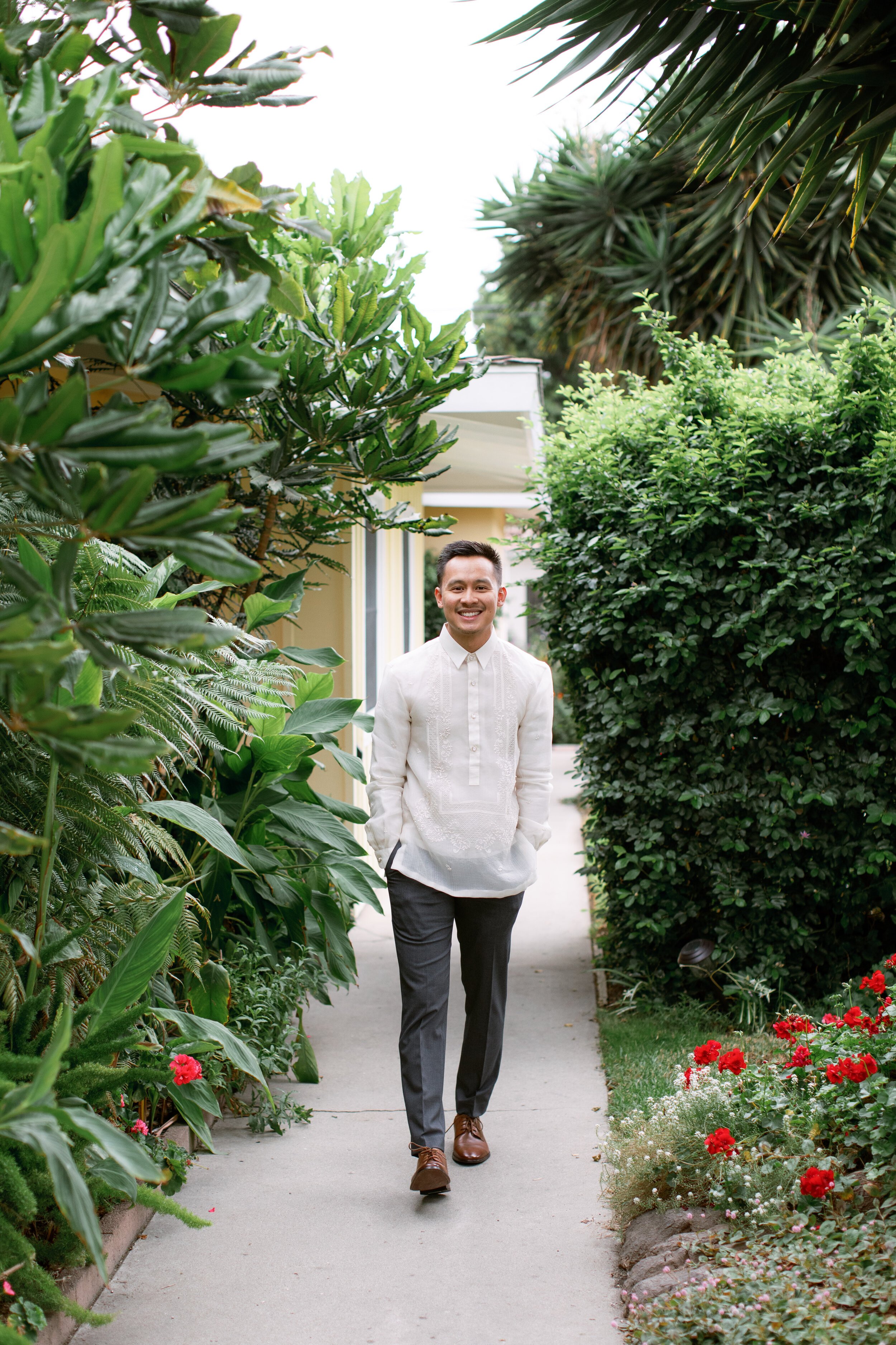 www.santabarbarawedding.com | Events by Fran | Chase Palm Park | Anna Delores Photography | Pineapple Industries | Groom Walking on Path Through Lush Greens