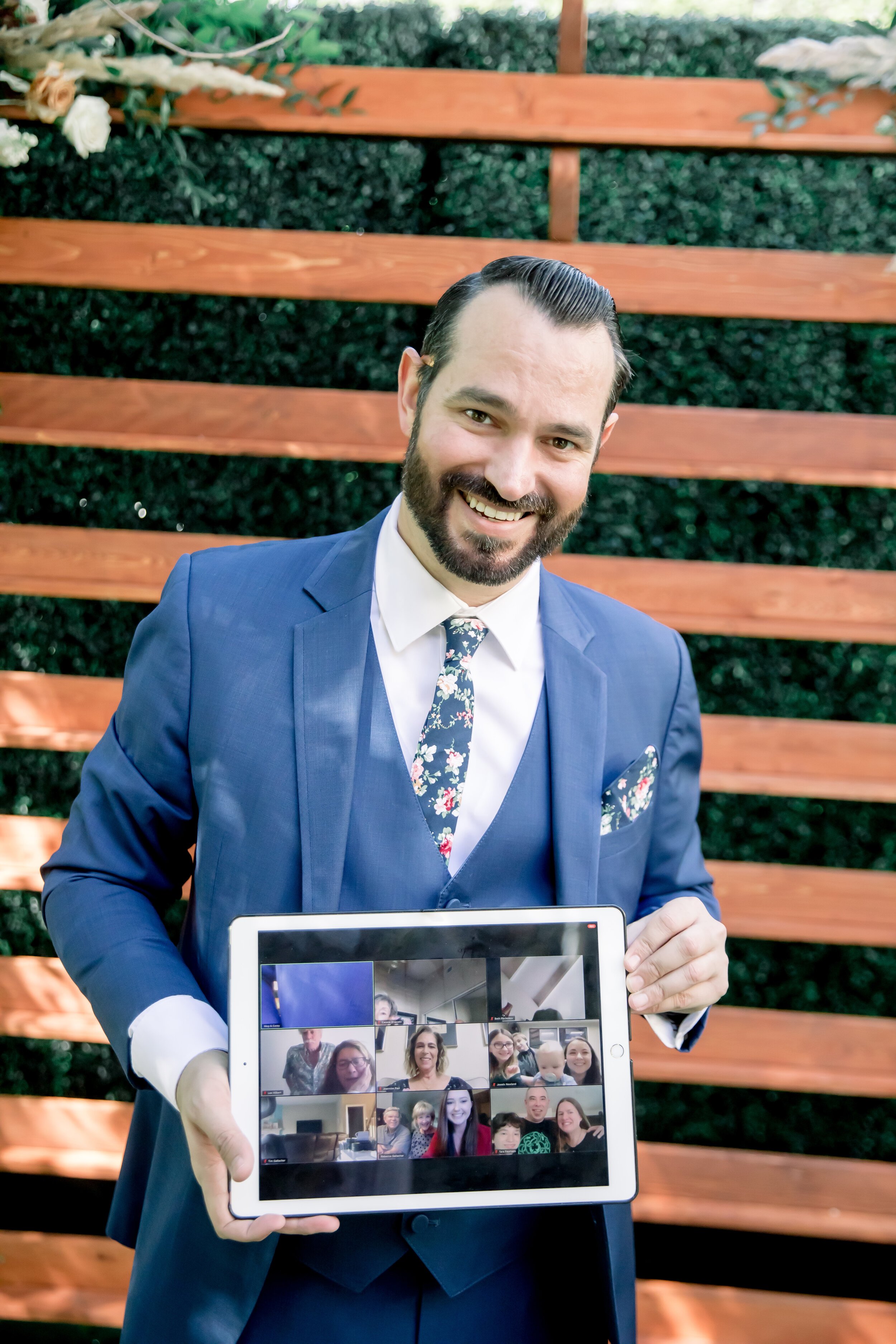 www.santabarbarawedding.com | Rewind Photography | Events by M and M | The Twisted Twig | Groom Holding Up iPad FaceTiming Family 
