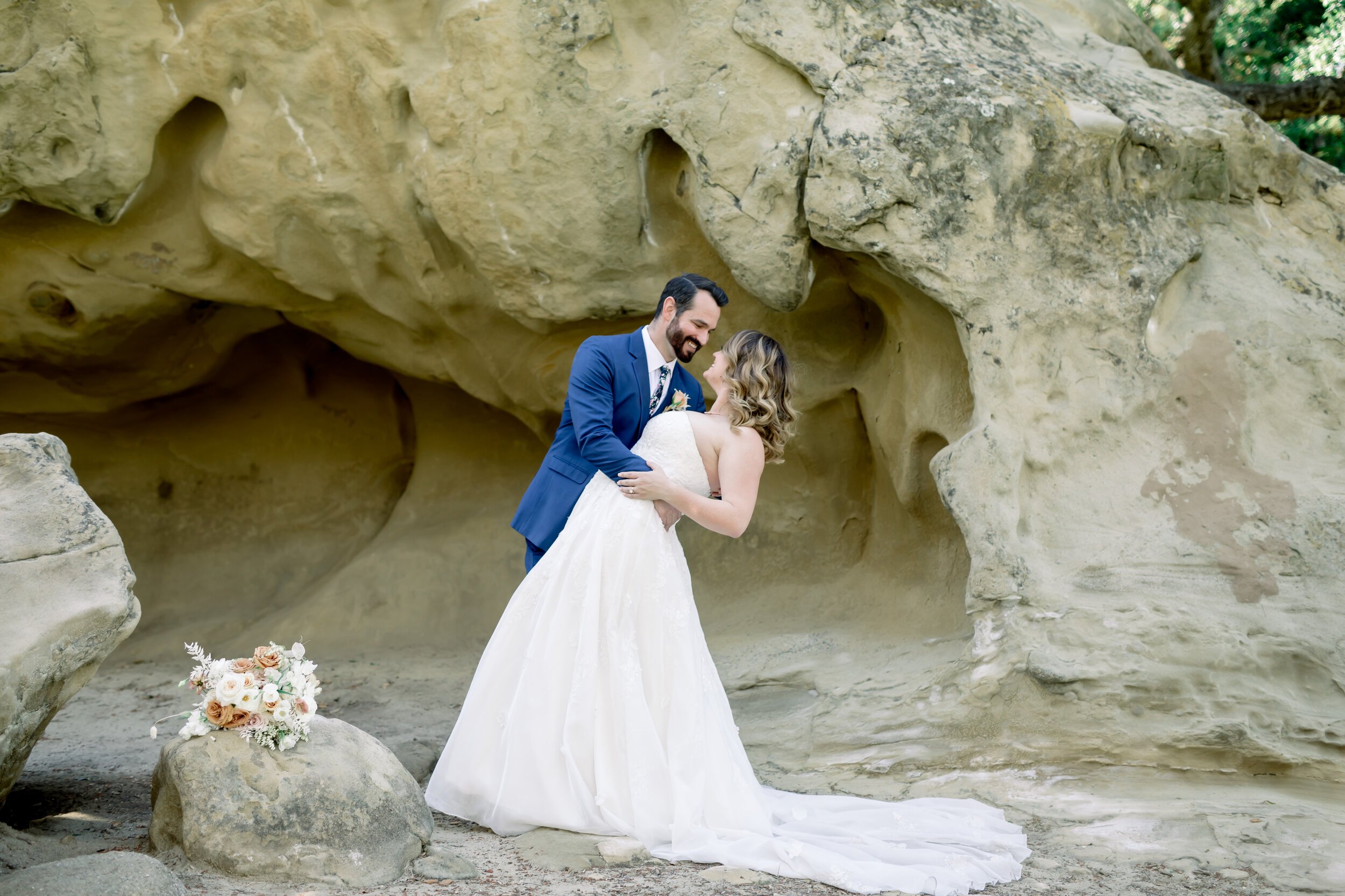 www.santabarbarawedding.com | Rewind Photography | Events by M and M | The Twisted Twig | Bliss Bridal Beauty | Bride and Groom Share a Moment on the Rocks