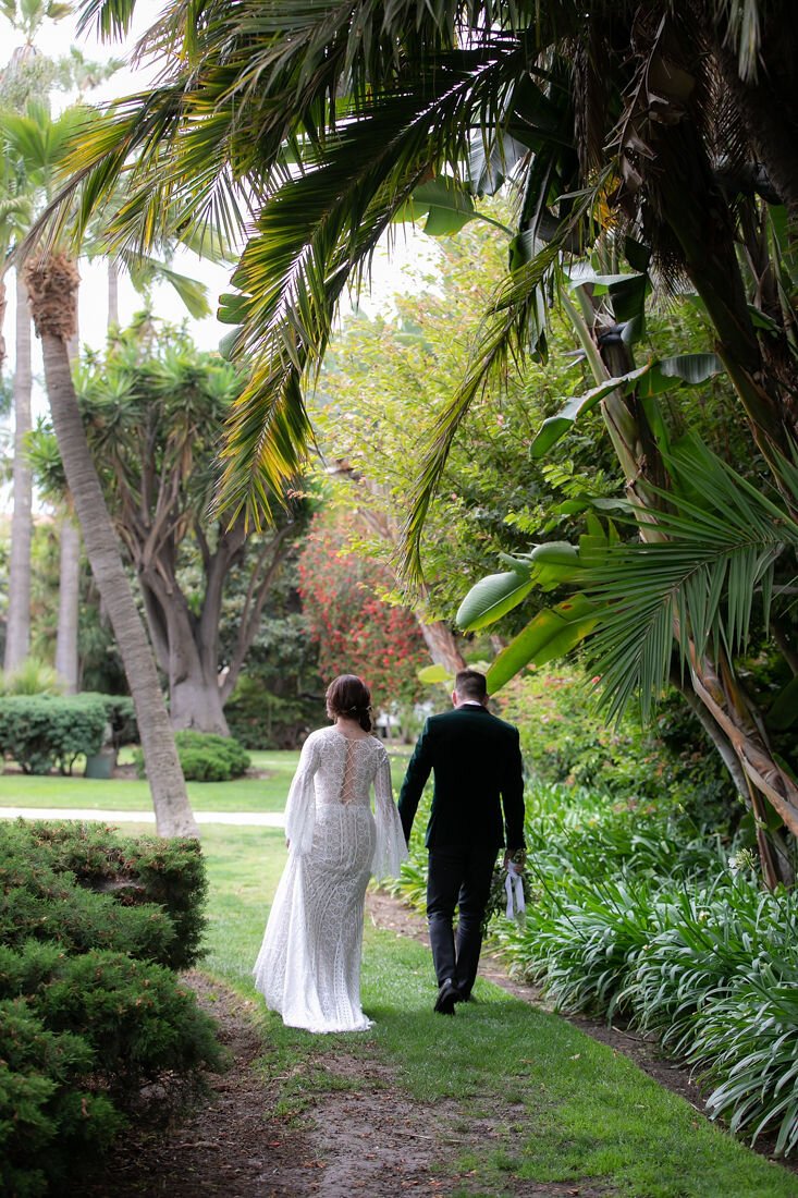 www.santabarbarawedding.com | Santa Barbara Courthouse | Claudia Craig | Garden Florist | BHLDN | Men’s Wearhouse | Willowby by Watters | Bride and Groom Walking Out of Courthouse Garden