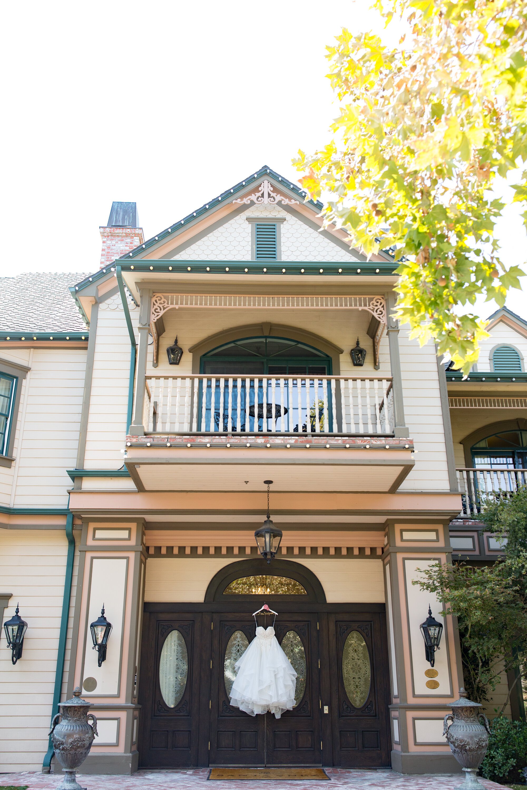 www.santabarbarawedding.com | Events by M and M | Kelsey Crews | Santa Ynez Inn | Wedding Gown Hanging from Venue Building