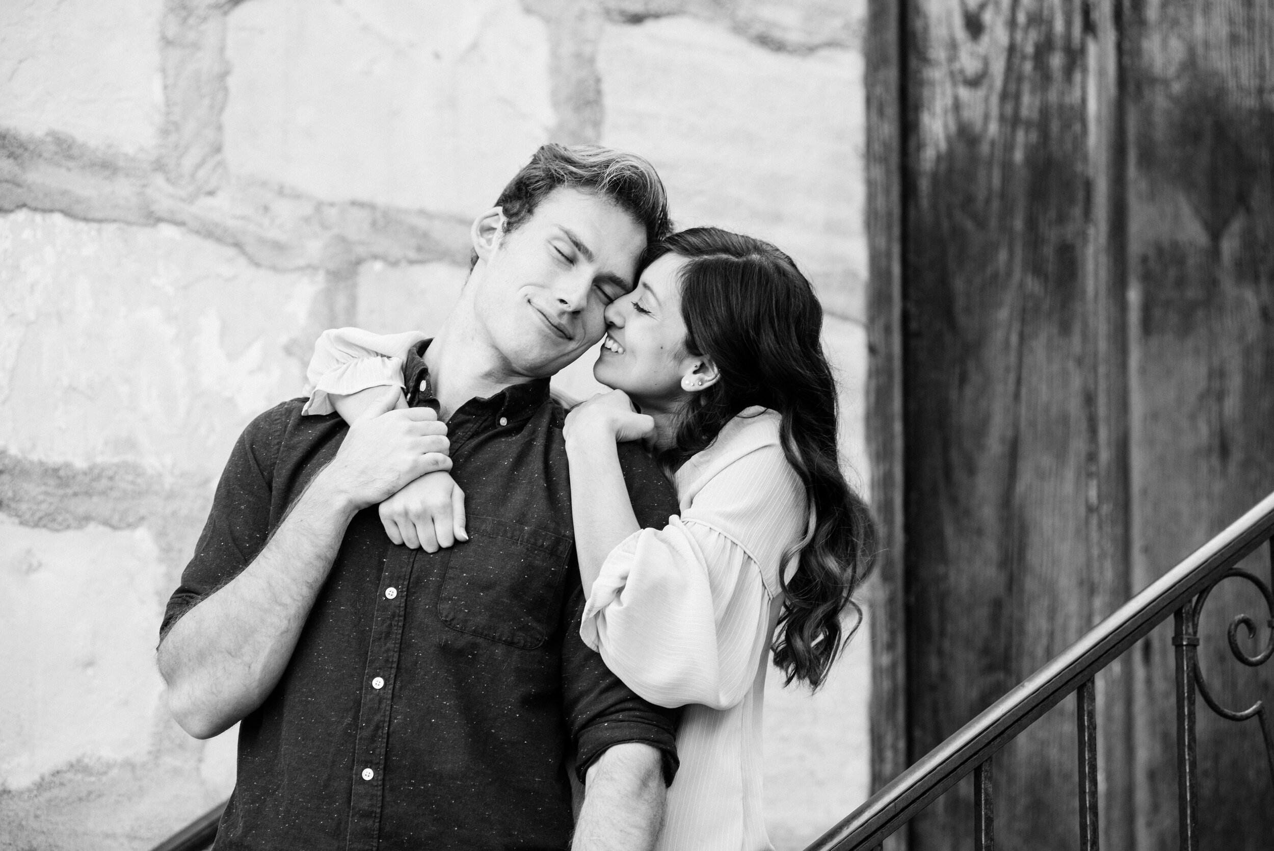 www.santabarbarawedding.com | ByCherry Photography | Old Mission Santa Barbara | Couple Embrace on the Stairs Outside the Old Mission