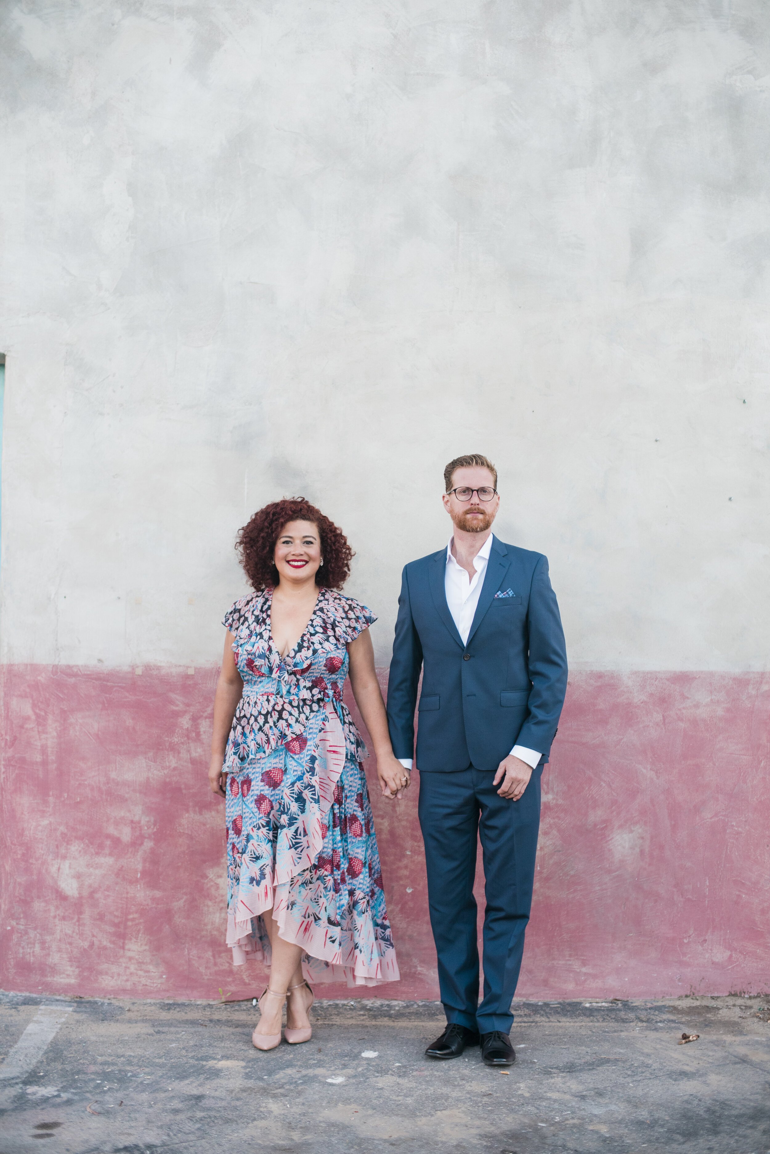 www.santabarbarawedding.com | ByCherry Photography | The Funk Zone | The Couple in Front of a Tan and Red Wall