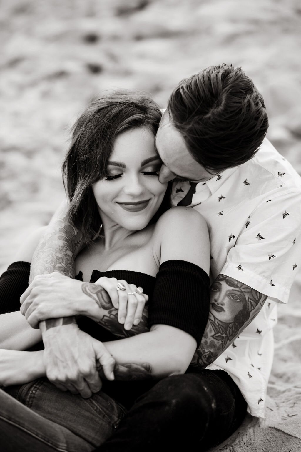 www.santabarbarawedding.com | Montecito | Julia Franzosa Photography | Engagement Photo of the Couple Sitting and Hugging on the Beach 
