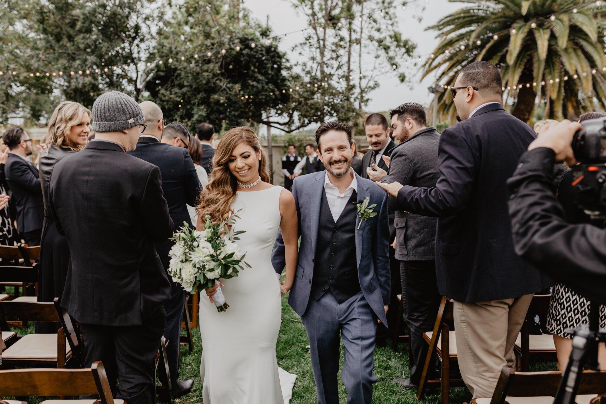 www.santabarbarawedding.com | Kyle London Photography | Santa Barbara Club | Sweet Pea Flowers | Theia | Moondance Bridal | Bride and Groom Leaving the Ceremony 