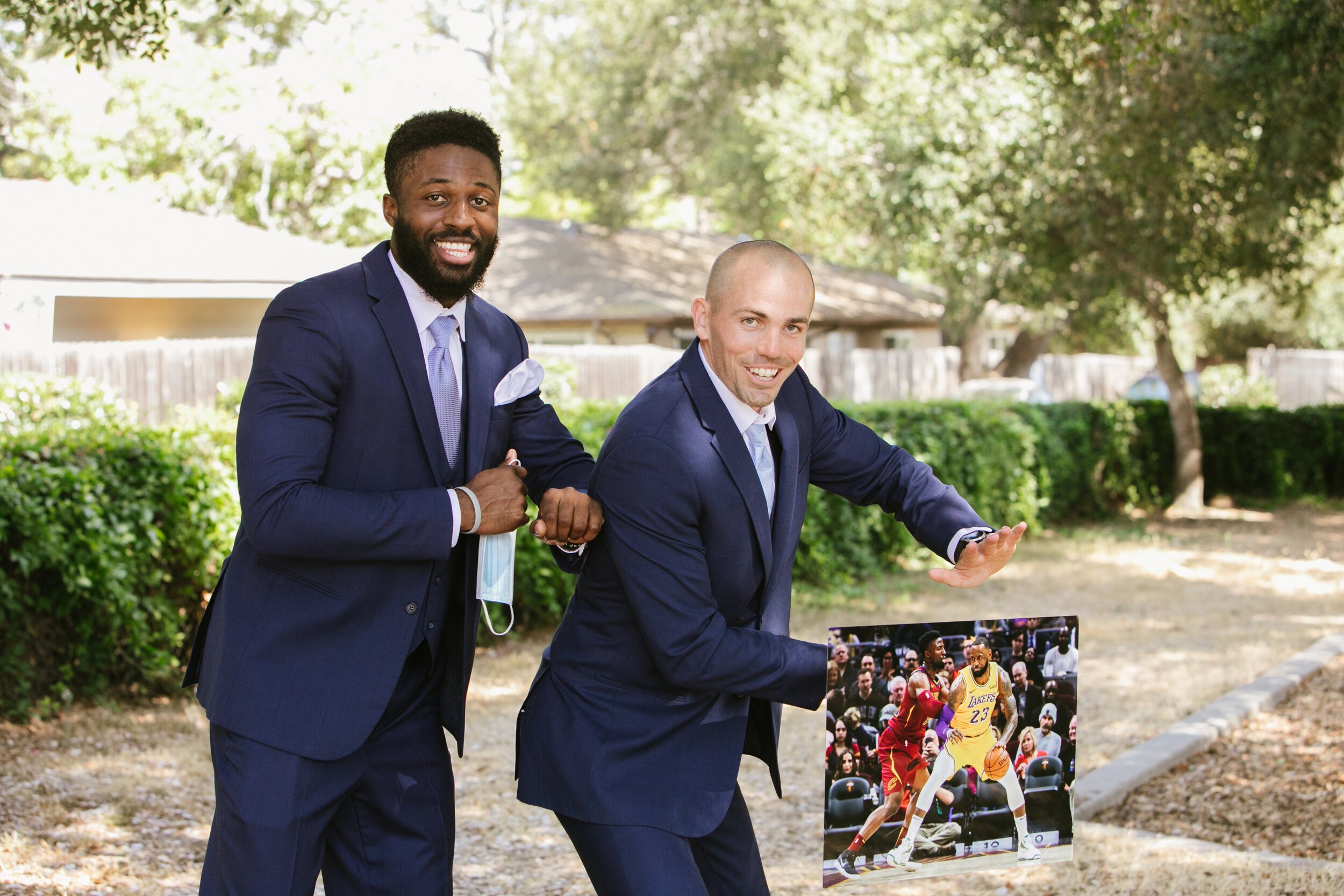 www.santabarbarawedding.com | ByCherry Photography | Floral Designs by Roni | Groom and Groomsman Pose with Picture of Lebron James