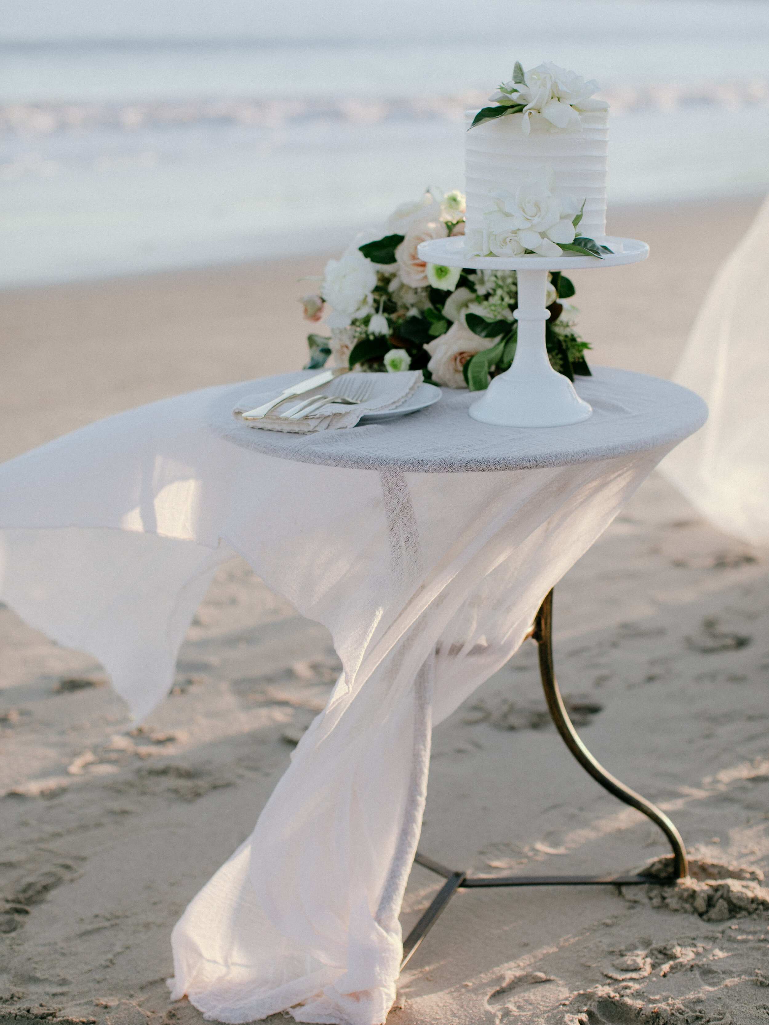 www.santabarbarawedding.com | East Beach | Santa Barbara Elopement | Chris J. Evans | Intrepid Floral Co. | Lele Patisserie | Table with Wedding Cake on the Beach