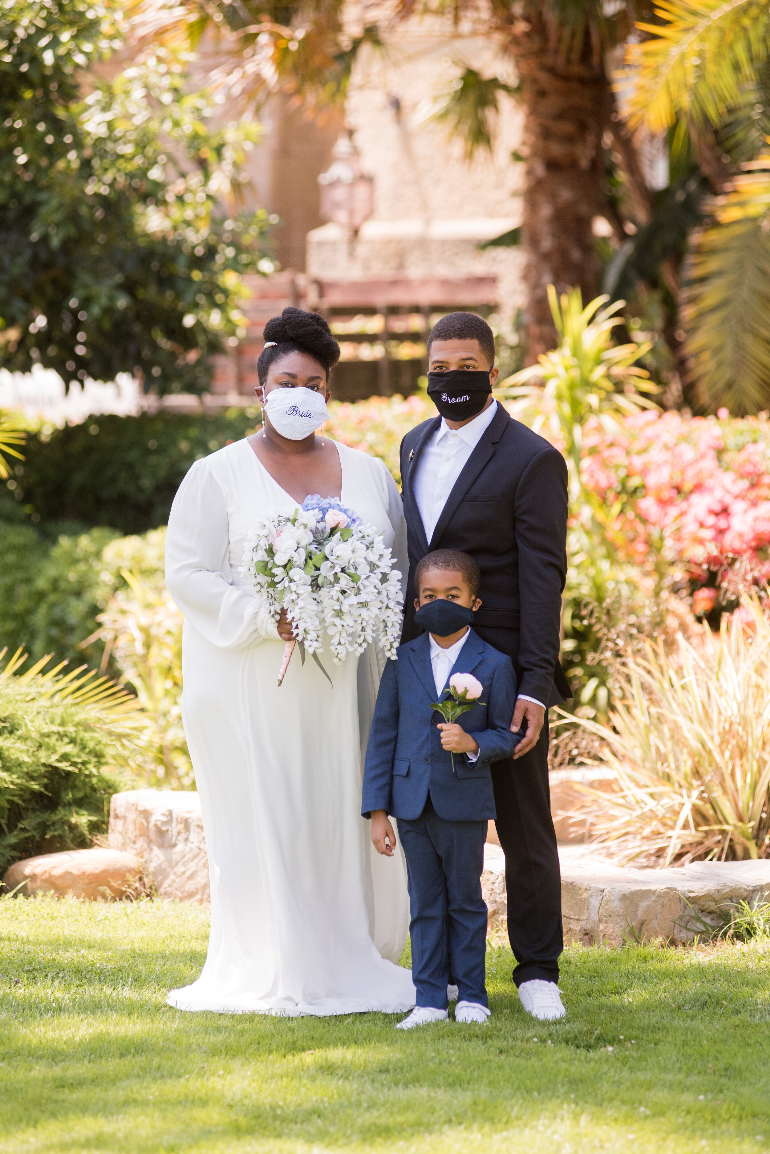 www.santabarbarawedding.com | ByCherry Photography | Santa Barbara Courthouse | Bride and Groom and Their Son  Outside the Courthouse with Their Masks On