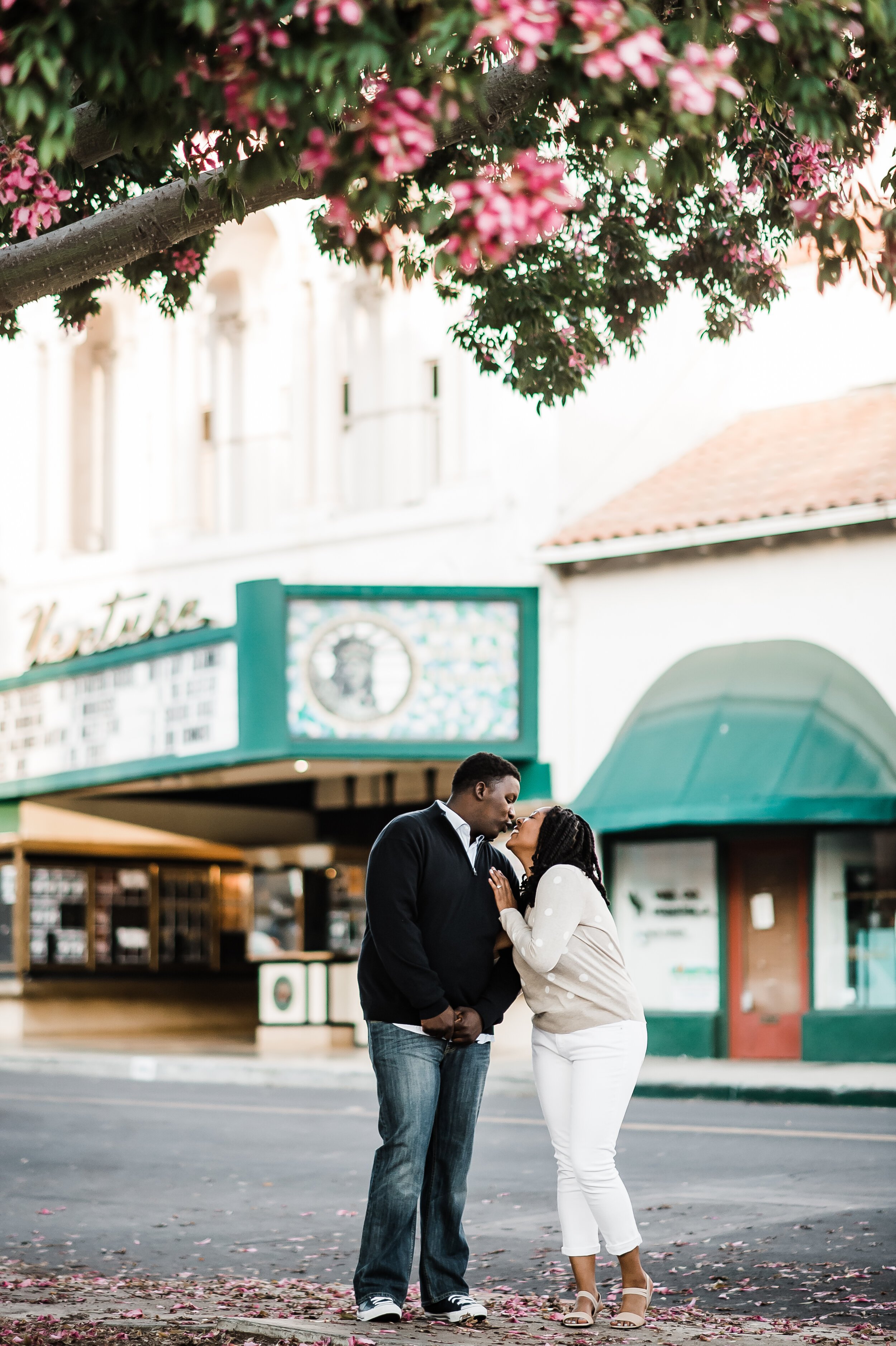 www.santabarbarawedding.com | Michelle Ramirez Photography | Couple in Front of Old Theater at Engagement Shoot in Downtown Ventura