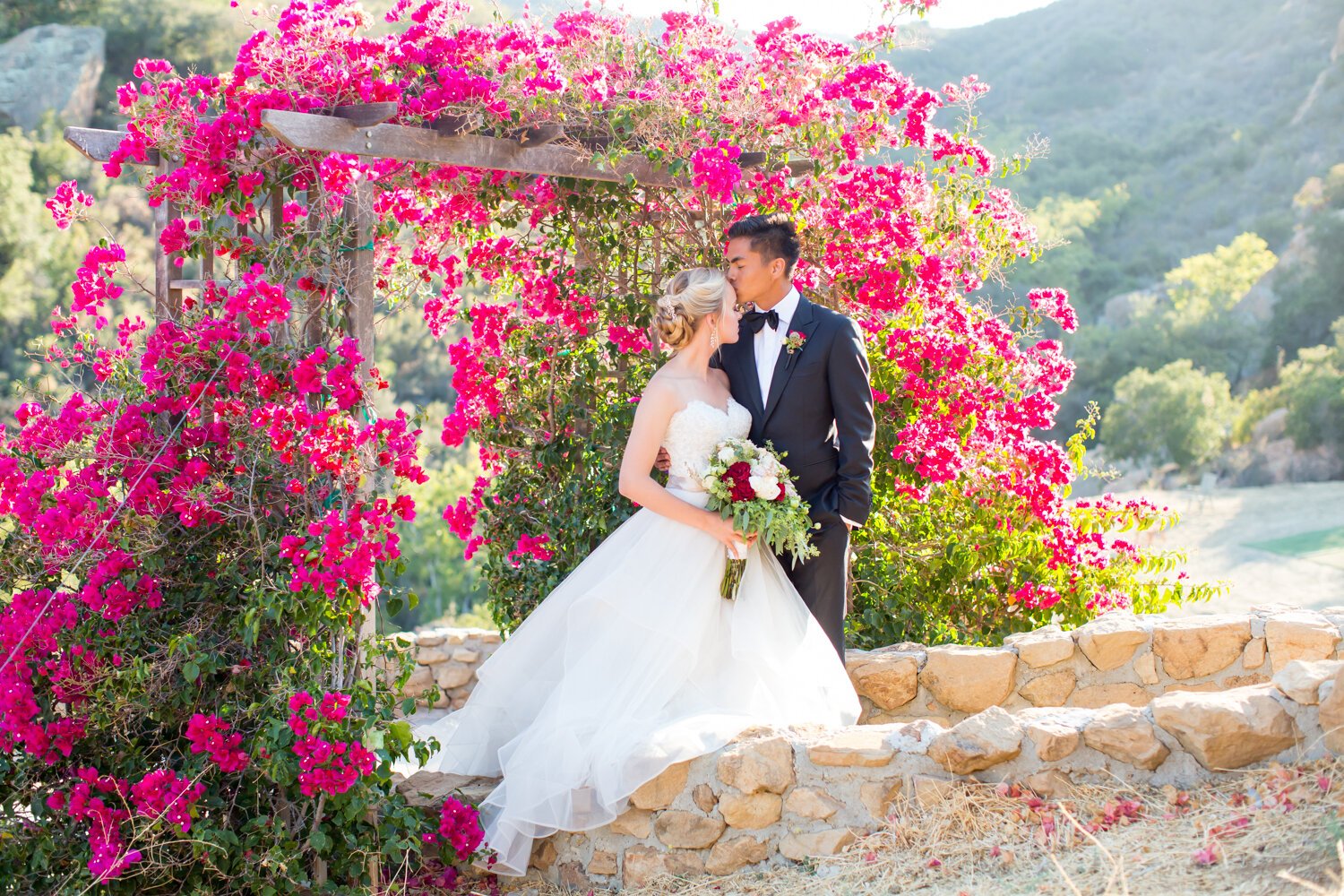 www.santabarbarawedding.com | APEX Malibu | Elizabeth Victoria Photography | Ebeling Events | Flowers by Maria | Malibu Clothes | BHLDN | Bride and Groom Under Flower Arch 