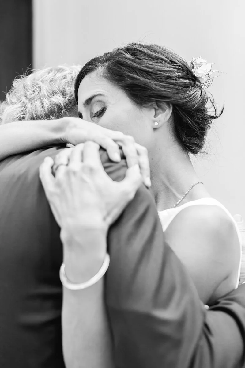 www.santabarbarawedding.com | Aurelia D’Amore Photography | Santa Barbara Courthouse | Haute Blossoms Floral | Alice and Olivia | Bride and Groom Embrace After Ceremony 