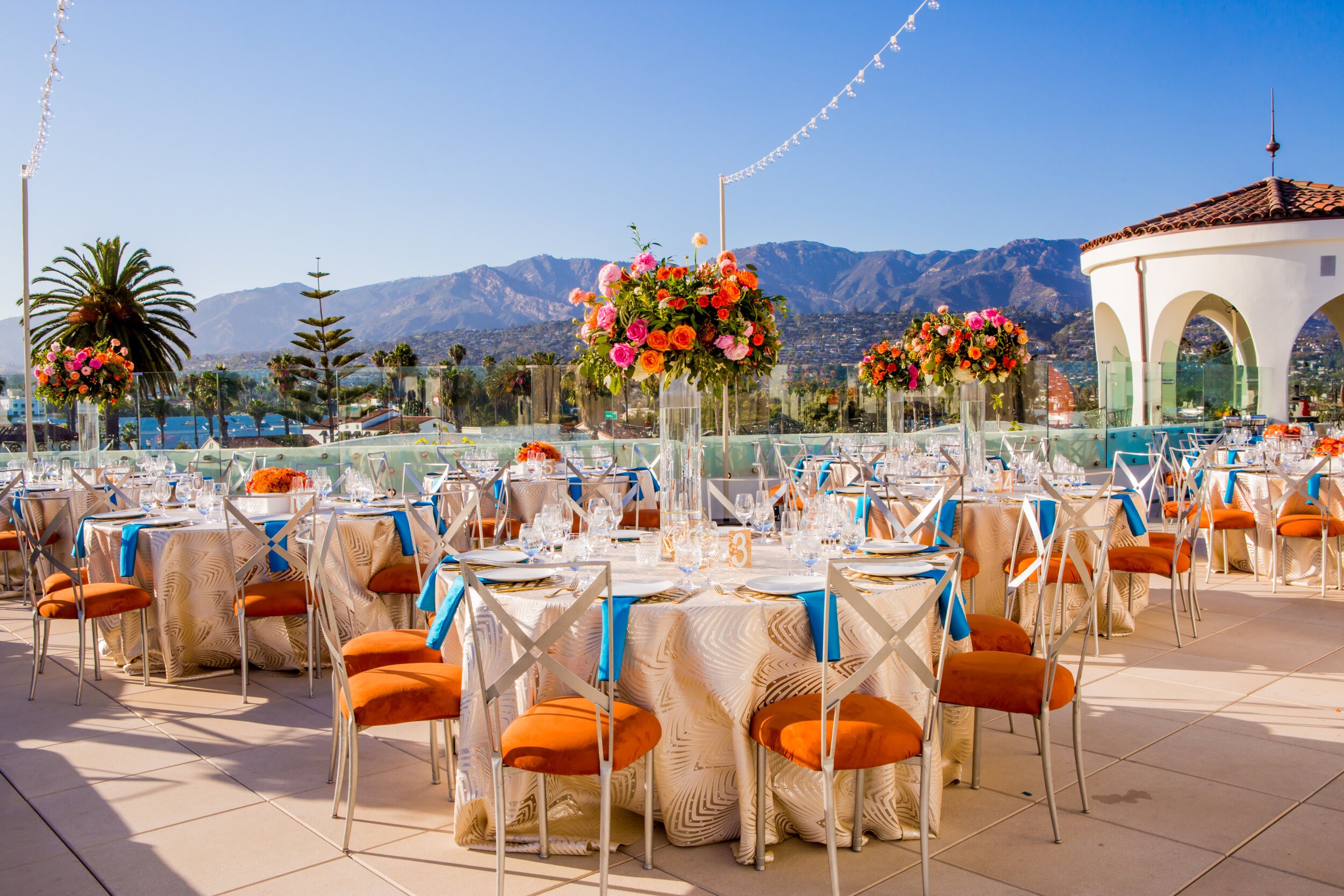 www.santabarbarawedding.com | Bright Event Rentals | Colorful Rooftop Reception with Mountains in the Background