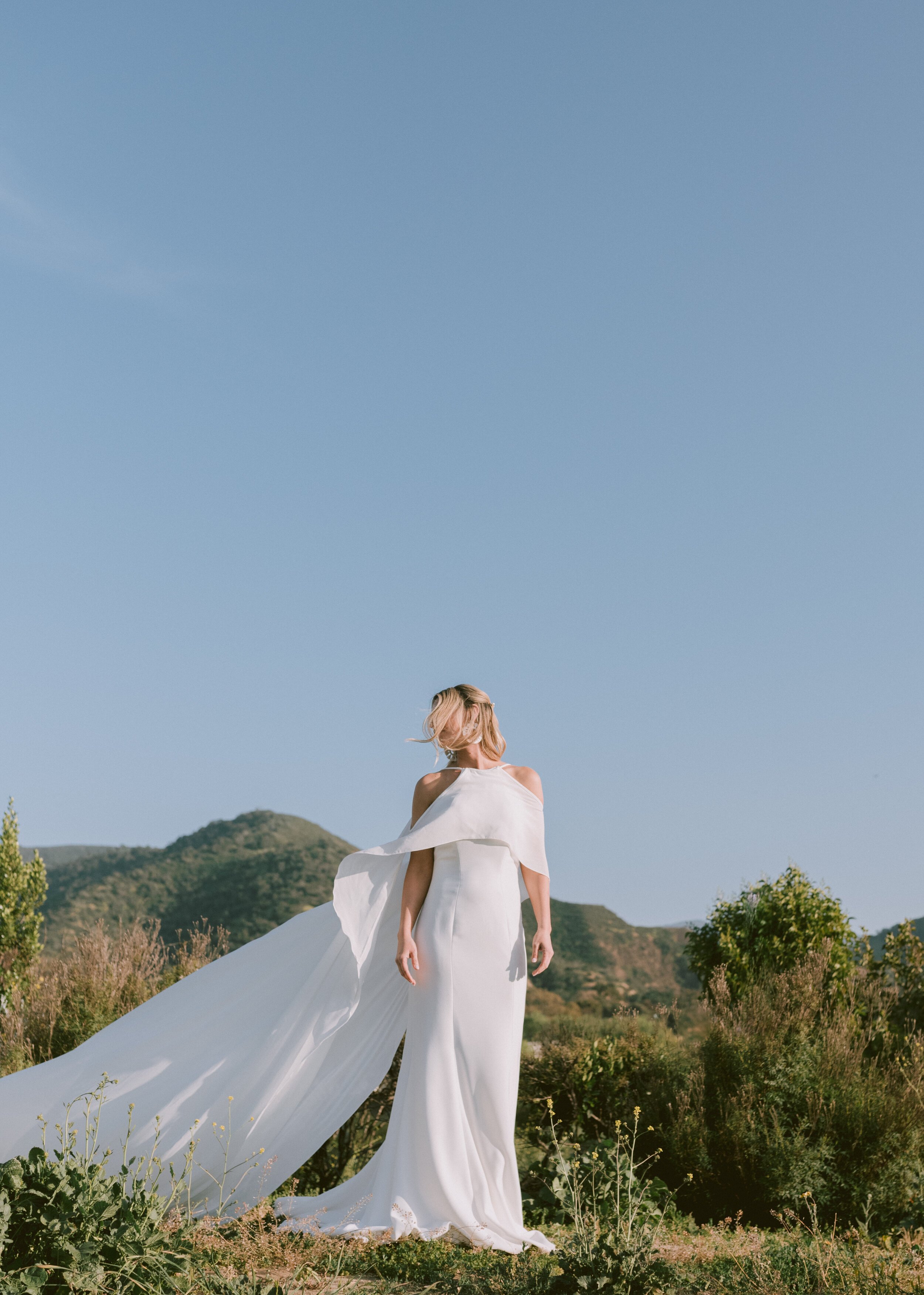 www.santabarbarawedding.com | Mollie Crutcher Photography | Flying Flags RV Resort &amp; Campground | Hive Events | flowy white wedding dress with cape