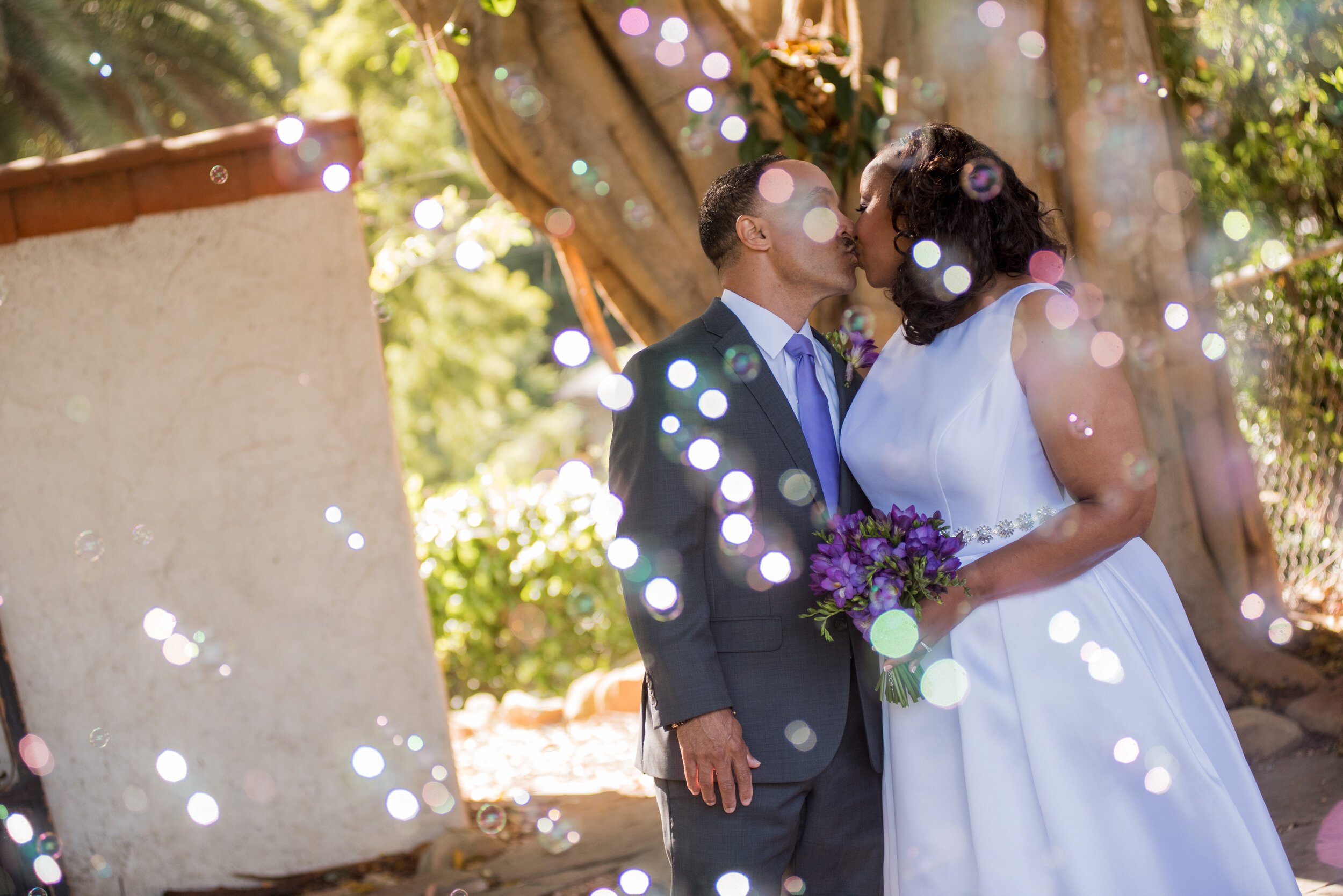 www.santabarbarawedding.com | ByCherry Photography | Riviera Productions | Bride and Groom Kiss with Bubbles