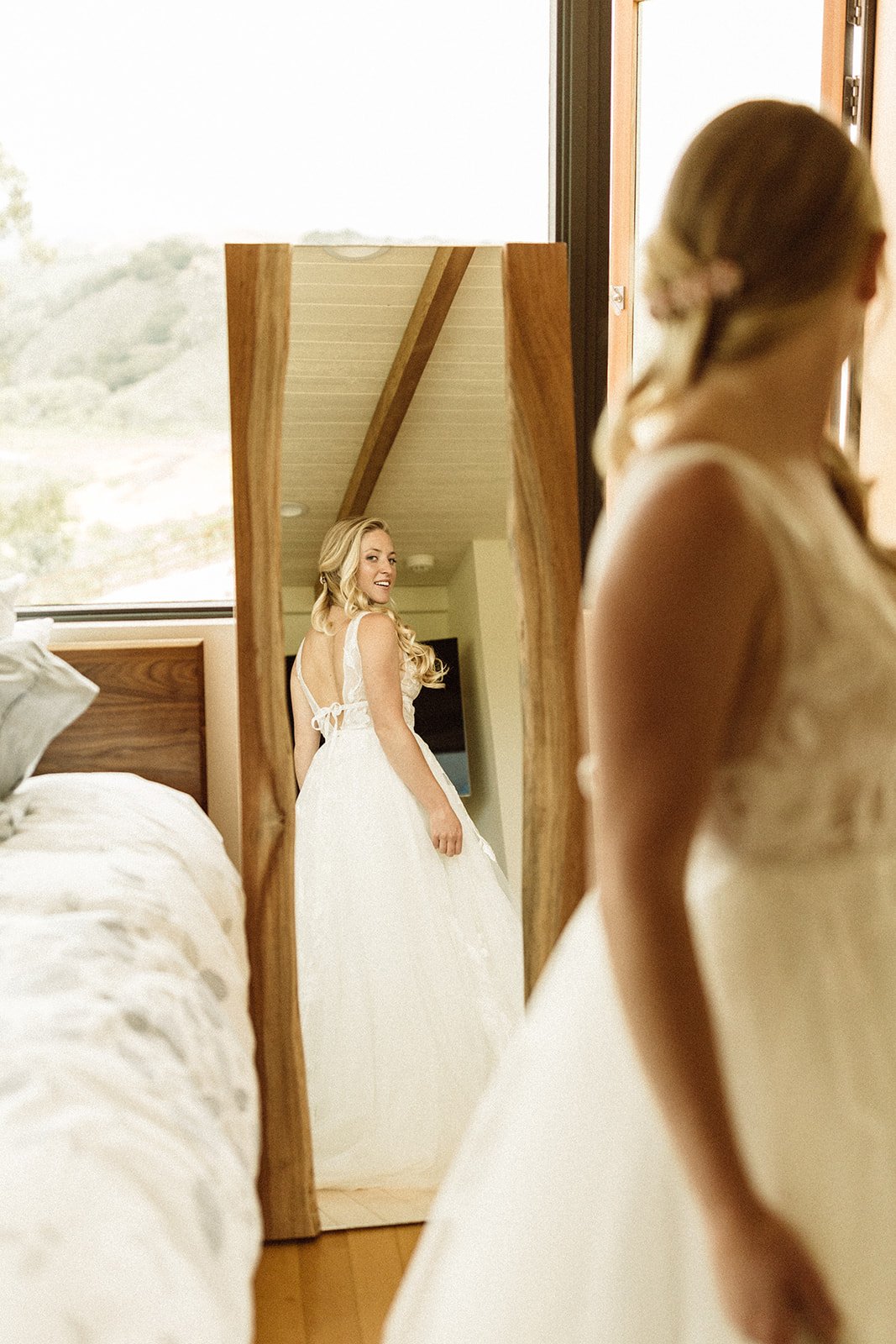www.santabarbarawedding.com | Isabella Griffith Photography | El Capitan State Beach | KB Events | Hair By Reilly | Tomiko Taft | Bride Admiring Dress in Mirror