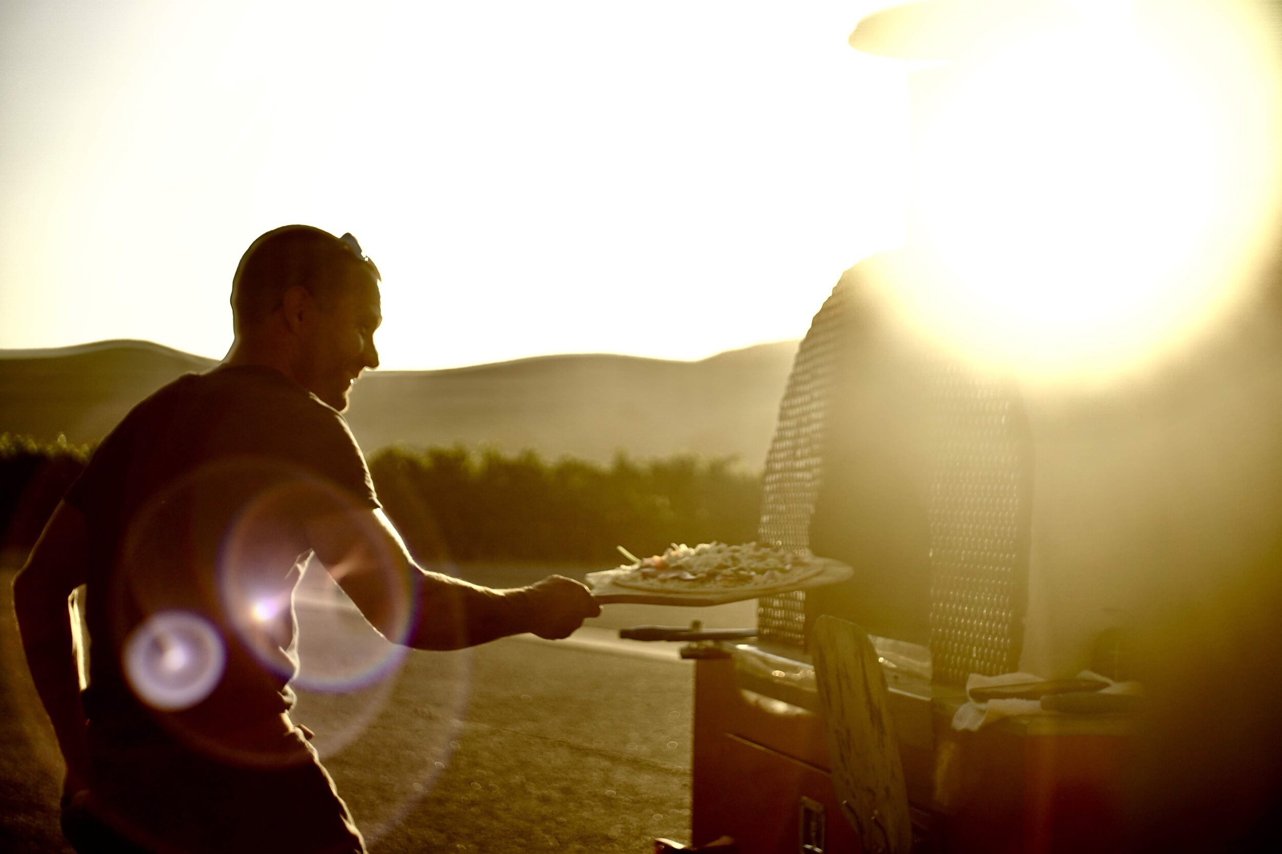 www.santabarbarawedding.com | Firefly Pizza Company | Putting a Pizza Into the Wood-Fired Oven