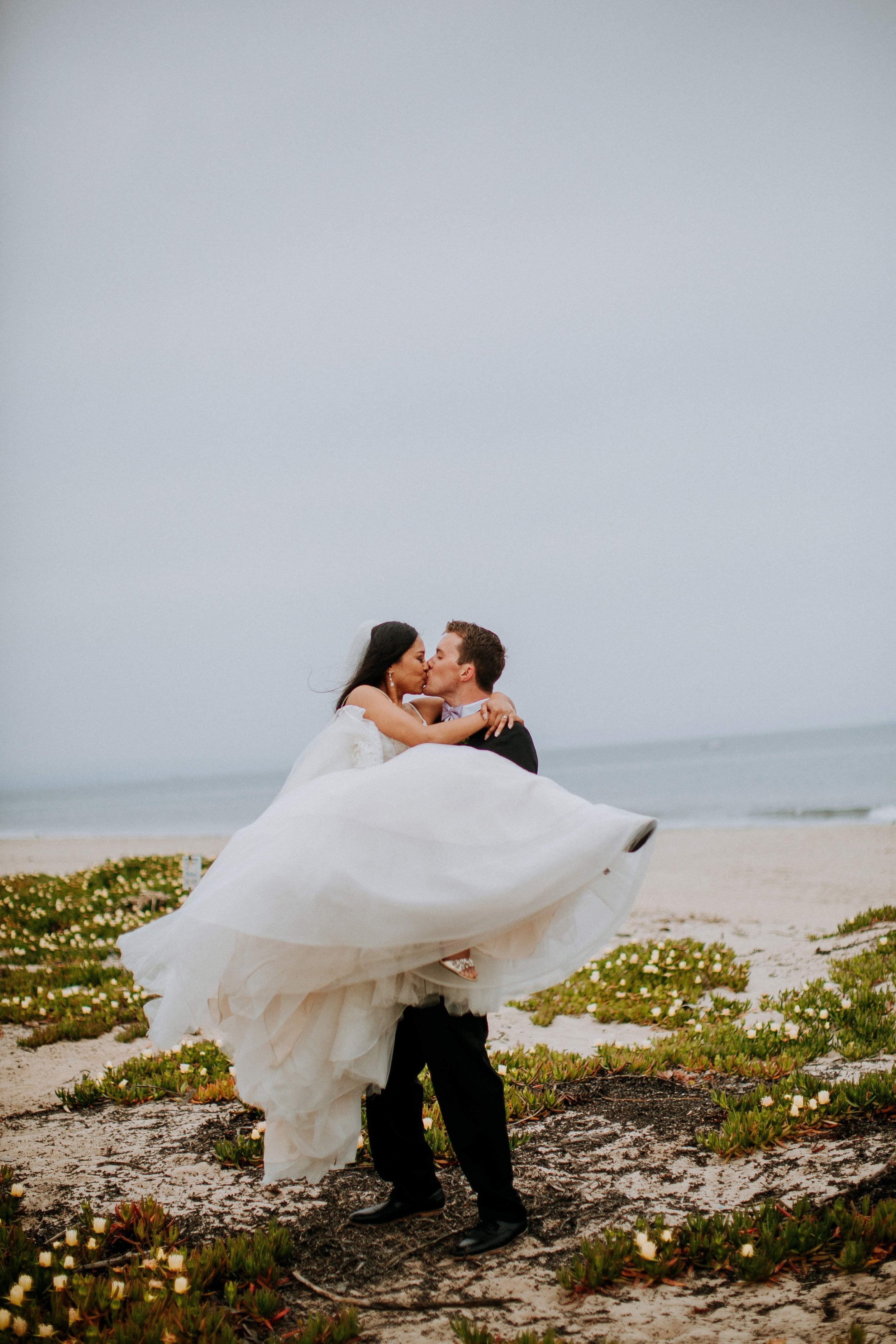www.santabarbarawedding.com | Candice Marie Photography | Hilton Santa Barbara Beachfront Resort | Dalina Klan | Once in a Lifetime Weddings | Bride and Groom Share a Kiss on the Beach
