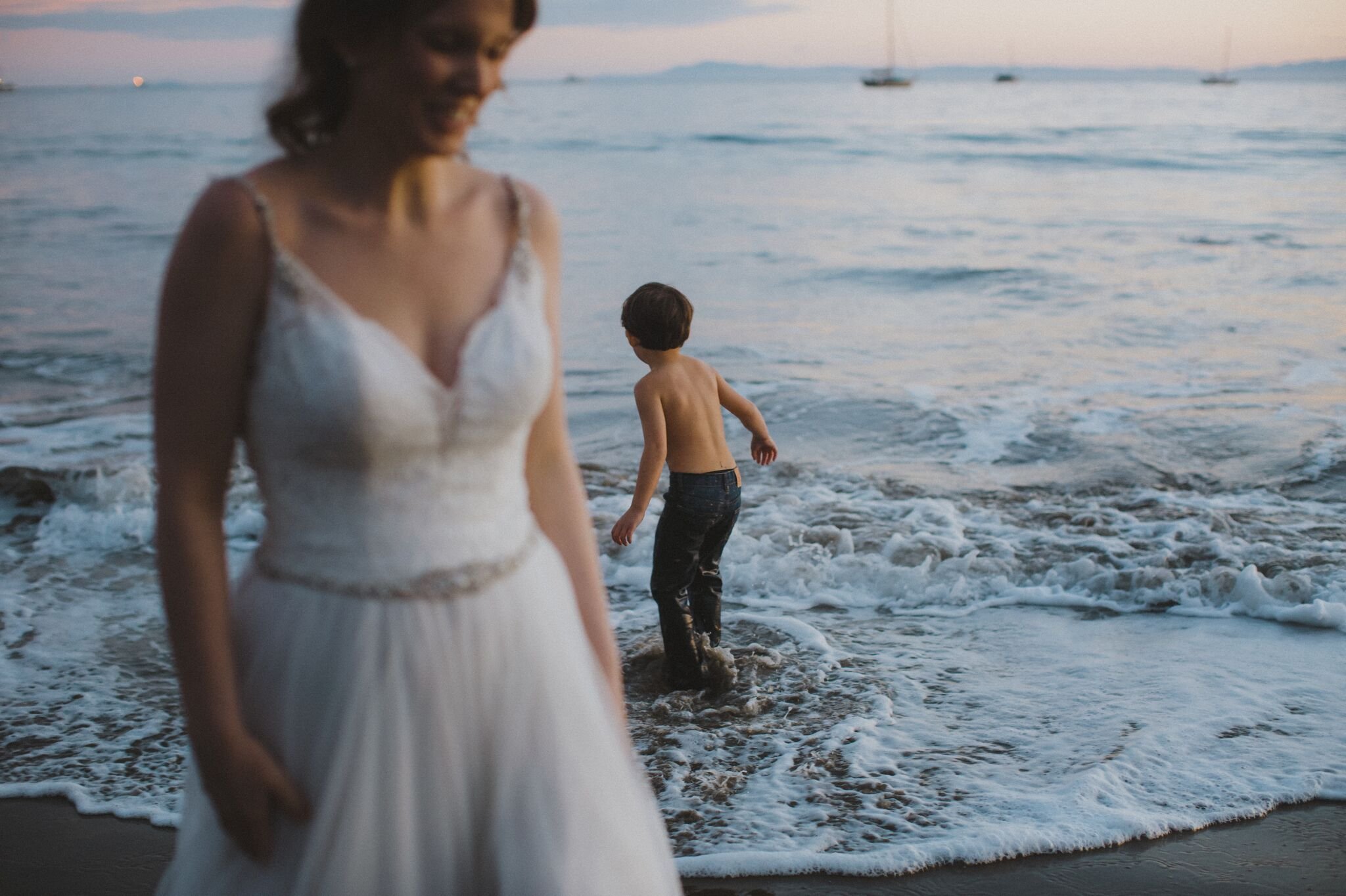 www.santabarbawedding.com | Venue: Santa Barbara Courthouse | Photography: Ryanne Bee Photography | Officiant: Santa Barbara Classic Weddings | Bride and Child Playing in the Sea
