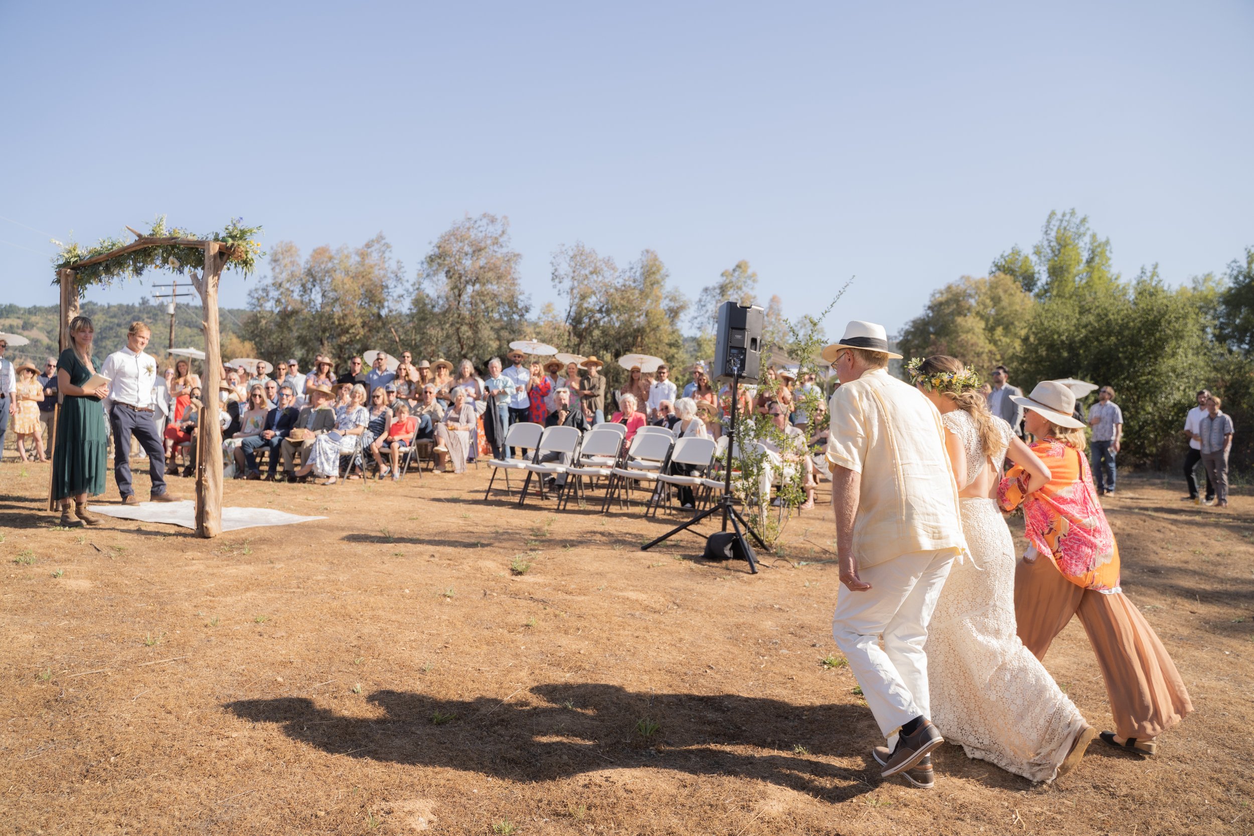 www.santabarbarawedding.com | Events by Fran | Jacob Grant Photography | Shiela Morales | Amigo Party Rentals | Daron Hope | Bride Walking Into Ceremony with Parents