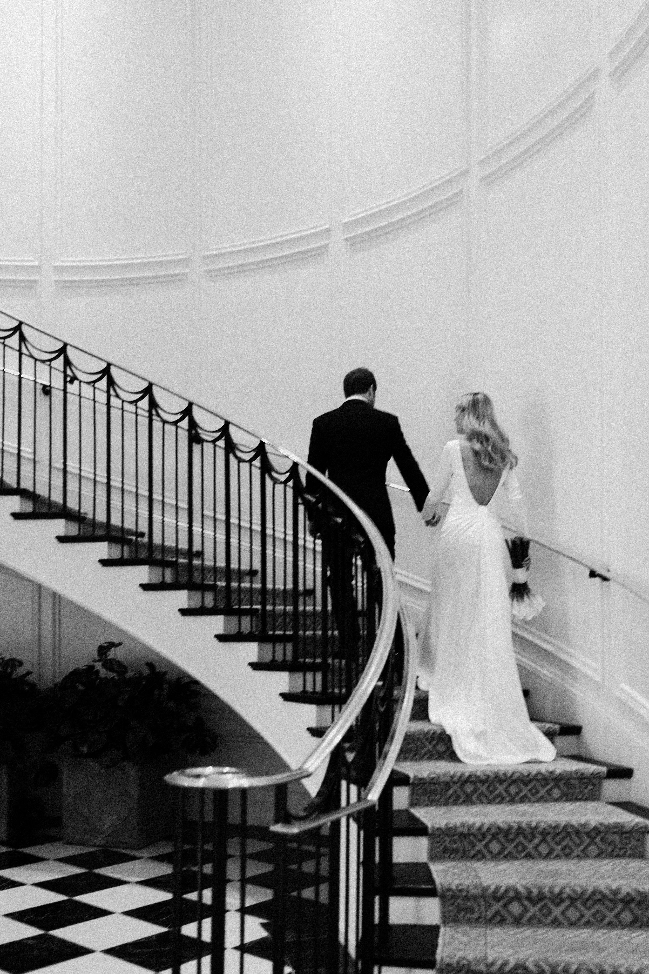 www.santabarbarawedding.com | Nicole Donnelly | Rosewood Miramar Beach | Alpha Floral | BHLDN | On Location Glam | Bride and Groom Walking Up Stairs