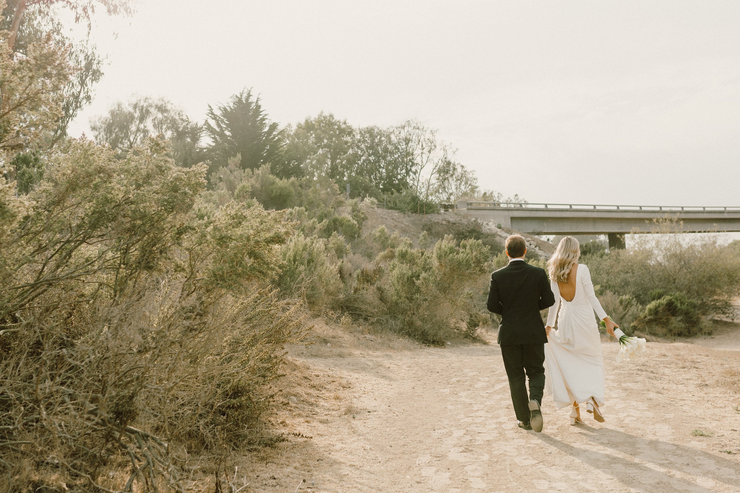 www.santabarbarawedding.com | Nicole Donnelly | Rosewood Miramar Beach | Alpha Floral | BHLDN | On Location Glam | Couple Walking on the Beach