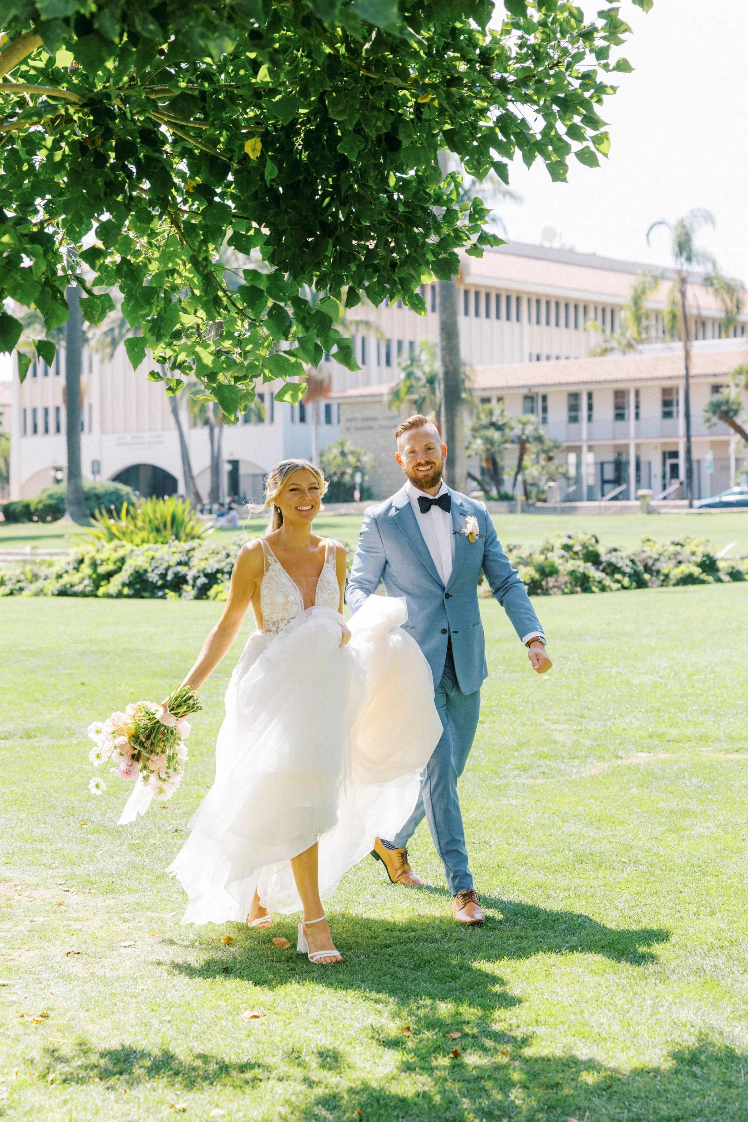 www.santabarbarawedding.com | The Santa Barbara Courthouse | Jen Rodriguez | Gatherings for Good | Blooms by Melly | Under the Veils | Bride and Groom Walking on Courthouse Lawn