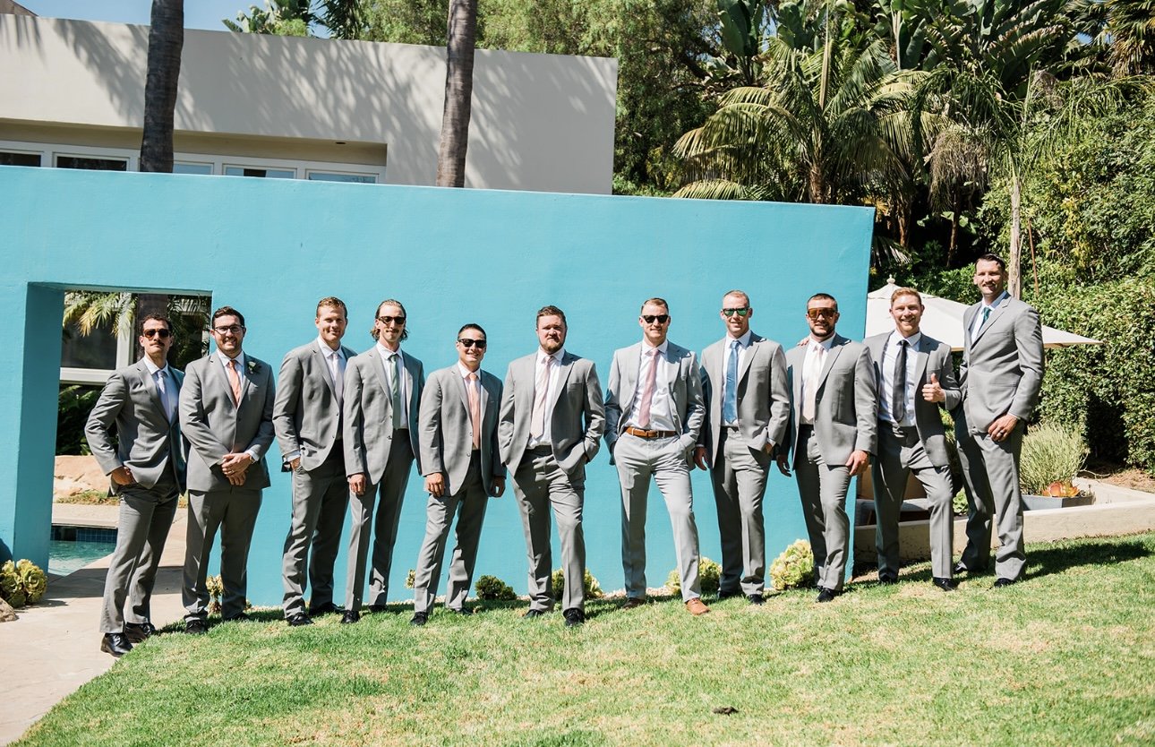www.santabarbarawedding.com | RG Photography | Events by Fran | Godric Grove | Groom and Groomsmen In Front of Blue Wall