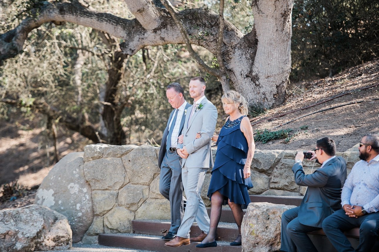 www.santabarbarawedding.com | RG Photography | Events by Fran | Godric Grove | Tangled Lotus | DJ Zeke | Groom Walking Into Ceremony with Parents