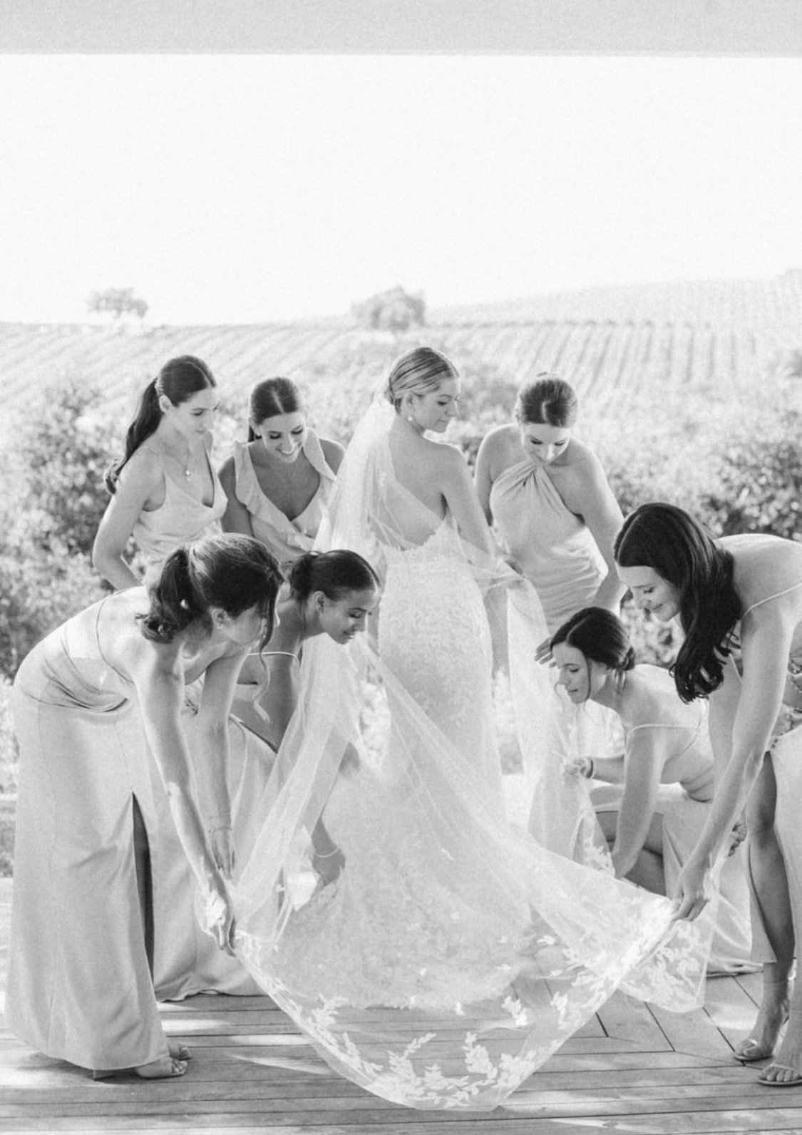 www.santabarbarawedding.com | Happy Canyon Vineyards | Bridesmaids Fixing Bride's Dress at Venue
