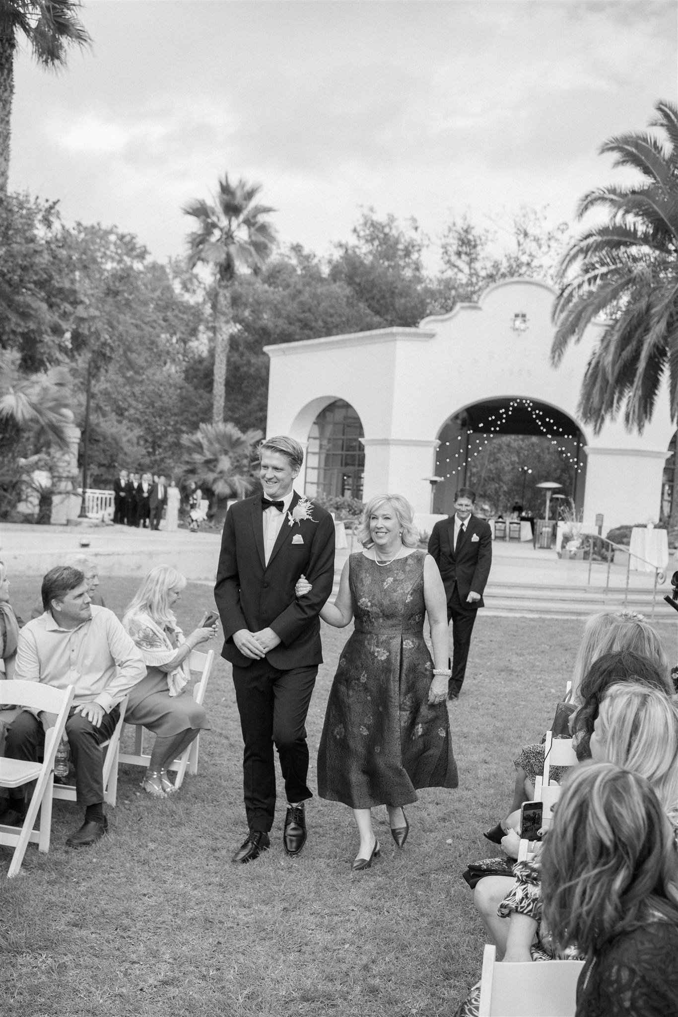 www.santabarbarawedding.com | Events by Fran | Wonder Tribe | Santa Barbara Courthouse | Wild West Florals | Amigo Party Rentals | Groom Walking Into Ceremony