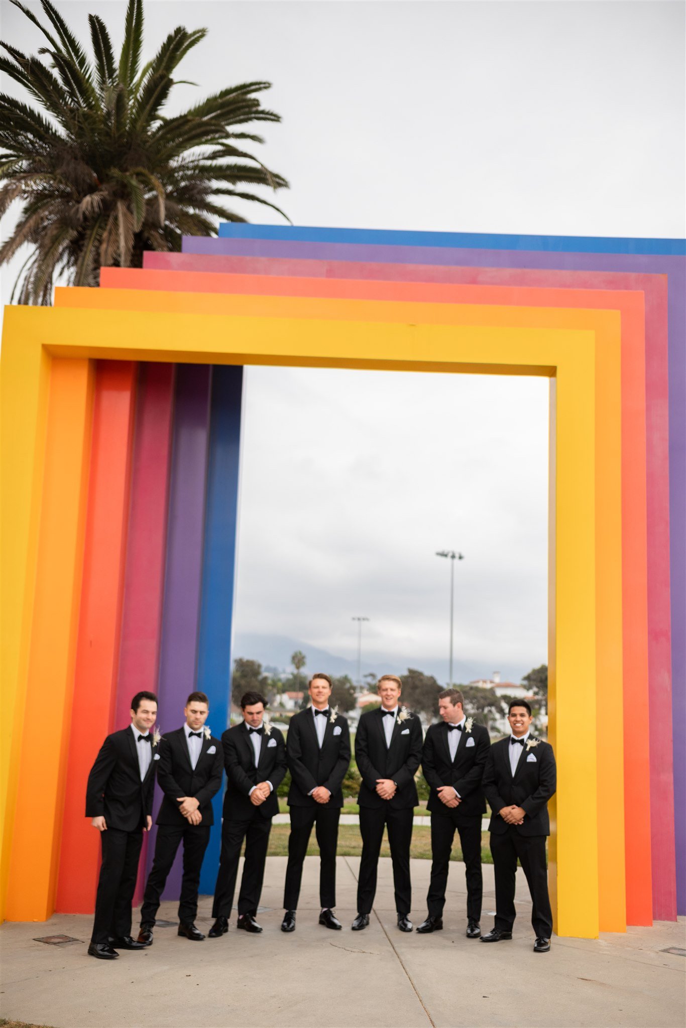 www.santabarbarawedding.com | Events by Fran | Wonder Tribe | Santa Barbara Courthouse | Groom and Groomsmen In Front of Rainbow Arches