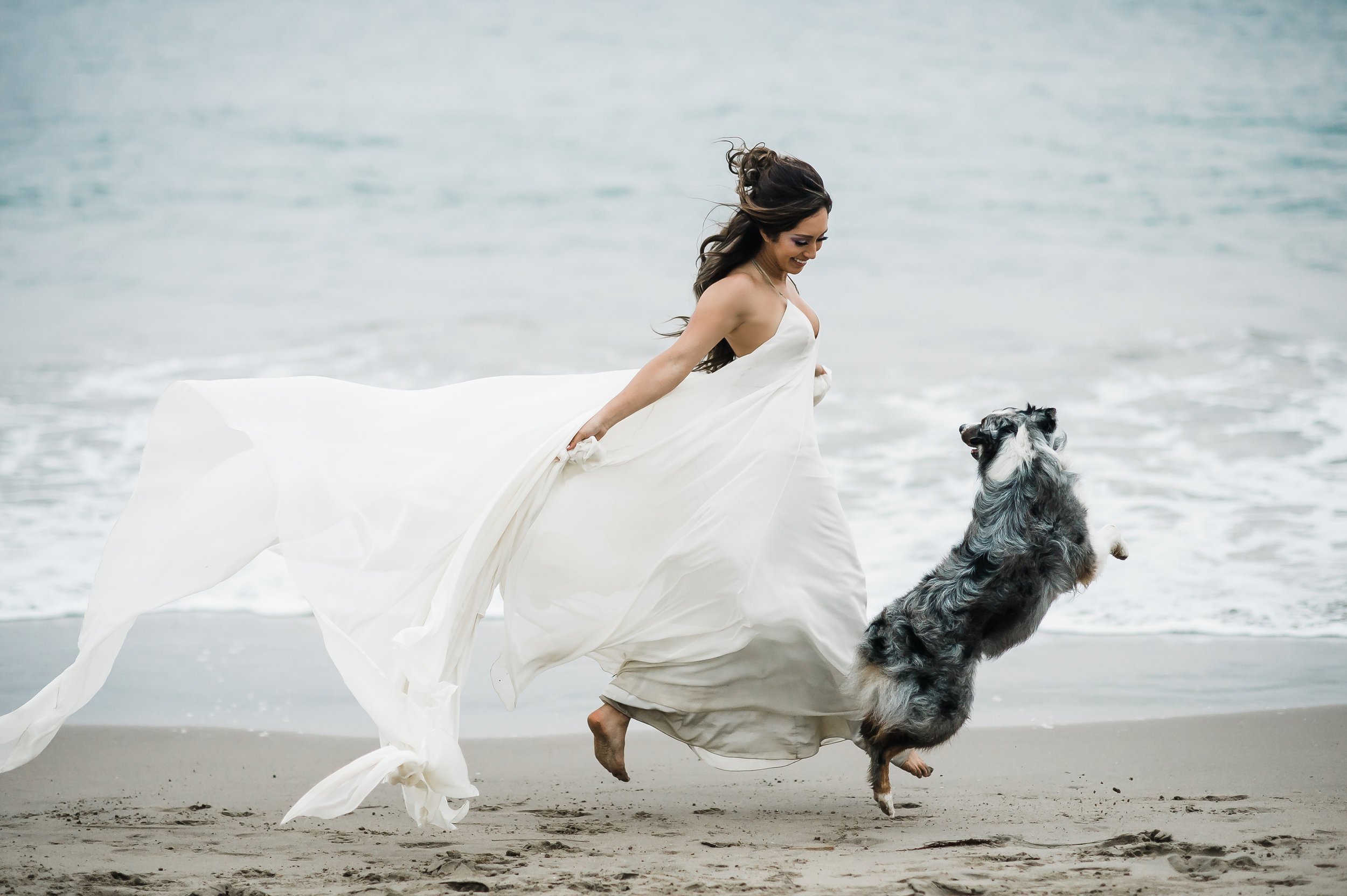 www.santabarbarawedding.com | Michelle Ramirez Photography | Bride Running On the Beach With Her Dog