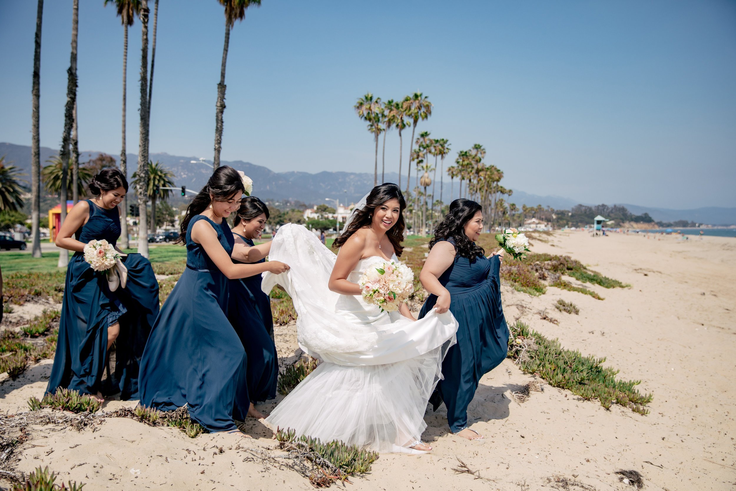 www.santabarbarawedding.com | Hilton Santa Barbara Beachfront Resort | Rewind Photography | Events by M and M | Bride Walking on Beach with Bridesmaids