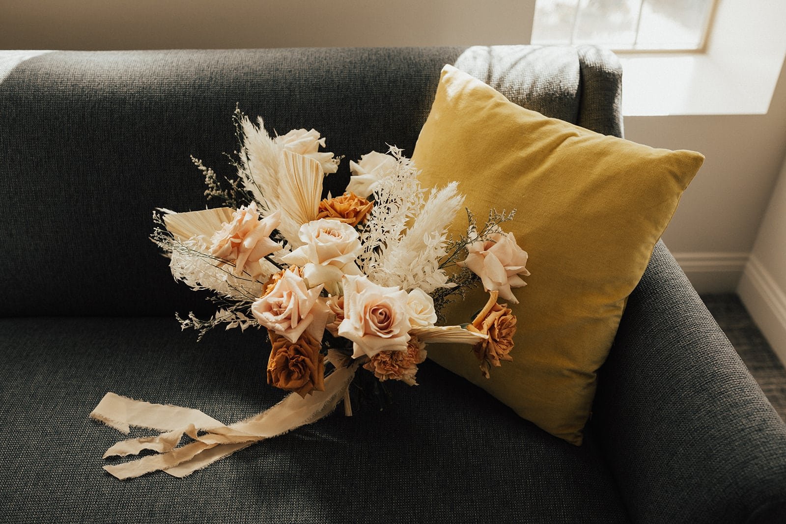www.santabarbarawedding.com | Ann Johnson Events | Foxen Canyon Ranch | Heirlume Photography | Bridal Bouquet on Couch