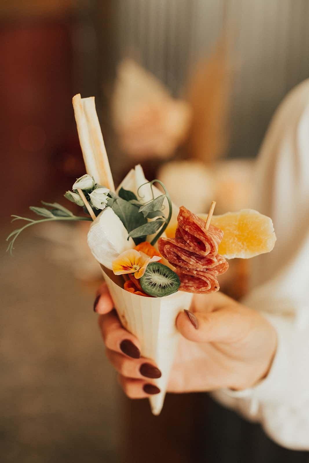 www.santabarbarawedding.com | Ann Johnson Events | Foxen Canyon Ranch | Heirlume Photography | Bride Holding an Appetizer in a Paper Cone