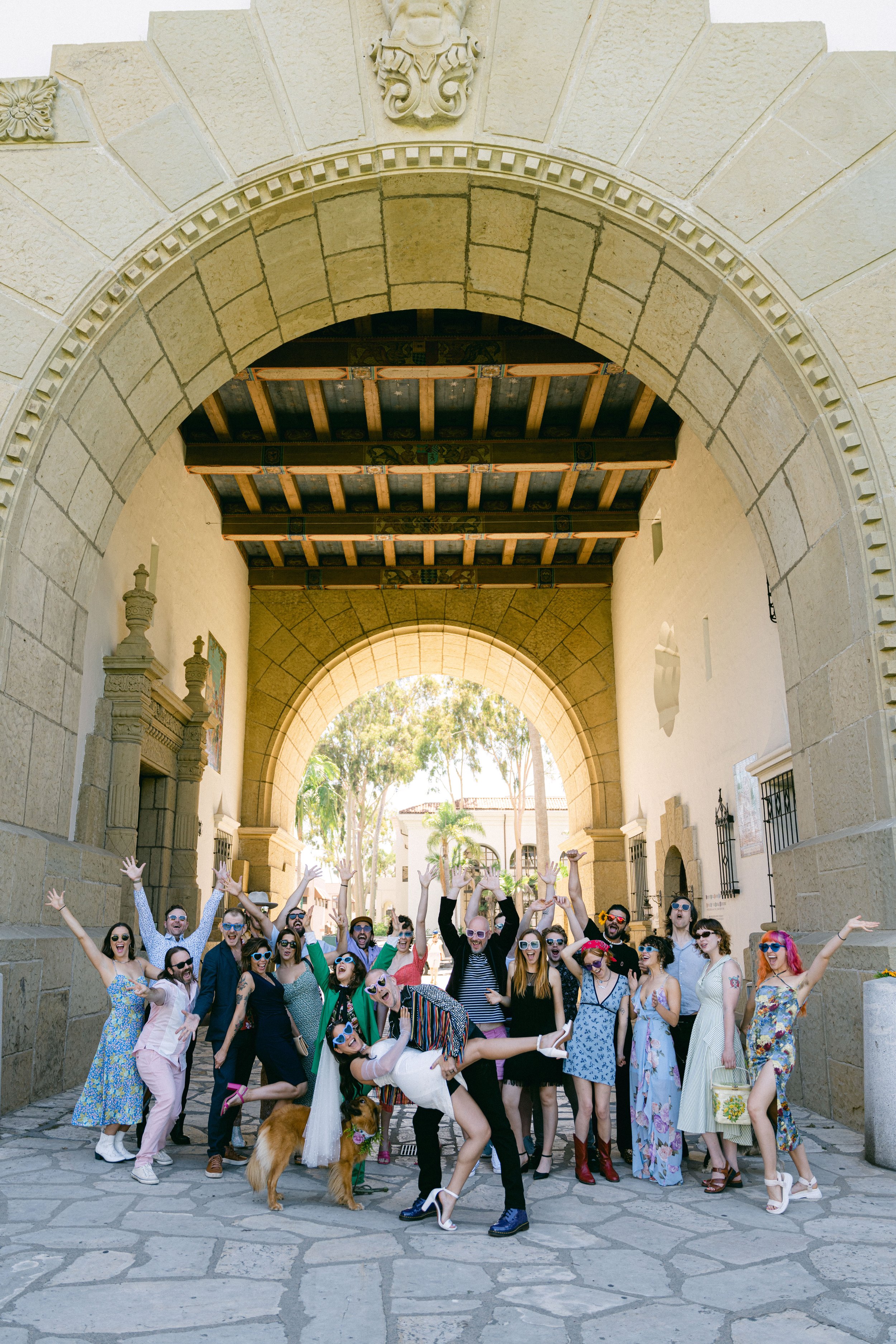 www.santabarbarawedding.com | Santa Barbara Courthouse | The Bomani’s | Couple Kissing In Front of Entire Wedding Party