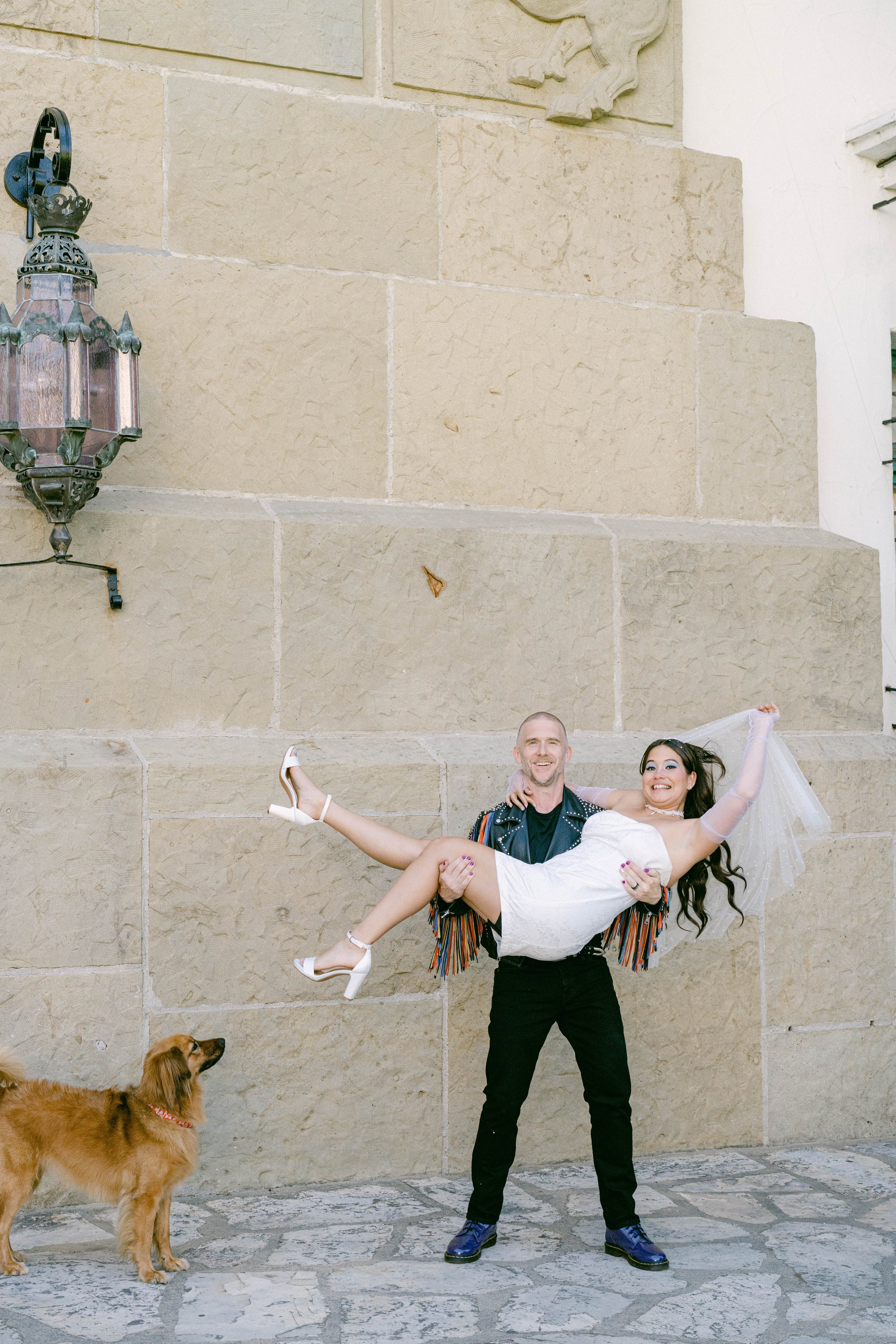 www.santabarbarawedding.com | Santa Barbara Courthouse | The Bomani’s | Groom Holding His Bride with Dog