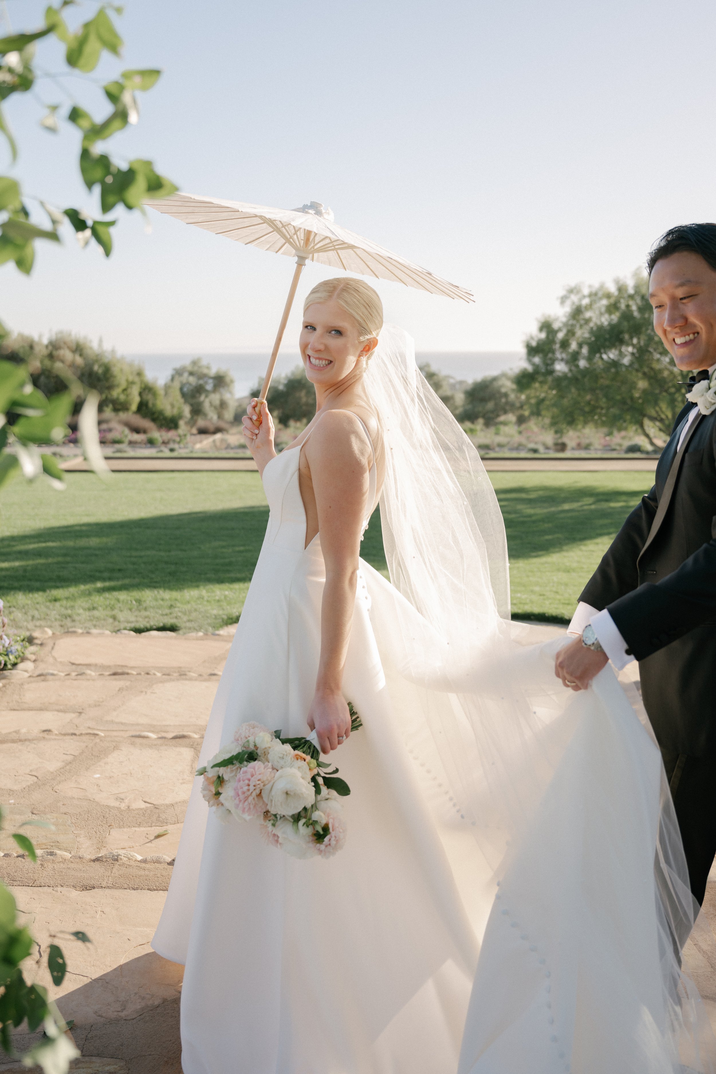 www.santabarbarawedding.com | Tonya Szele | Haley Garces | Tuscan Hills | Ella &amp; Louie | Carlyle Salon | Bride and Groom Walking Under Umbrella